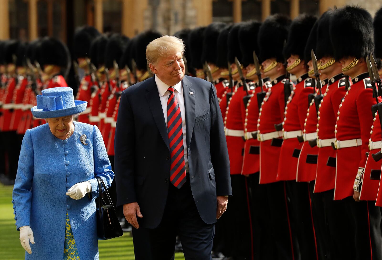 FILE - President Donald Trump and Britain's Queen Elizabeth II inspect a Guard of Honour, formed of the Coldstream Guards at Windsor Castle in Windsor, England, July 13, 2018. (AP Photo/Matt Dunham, Pool, File)