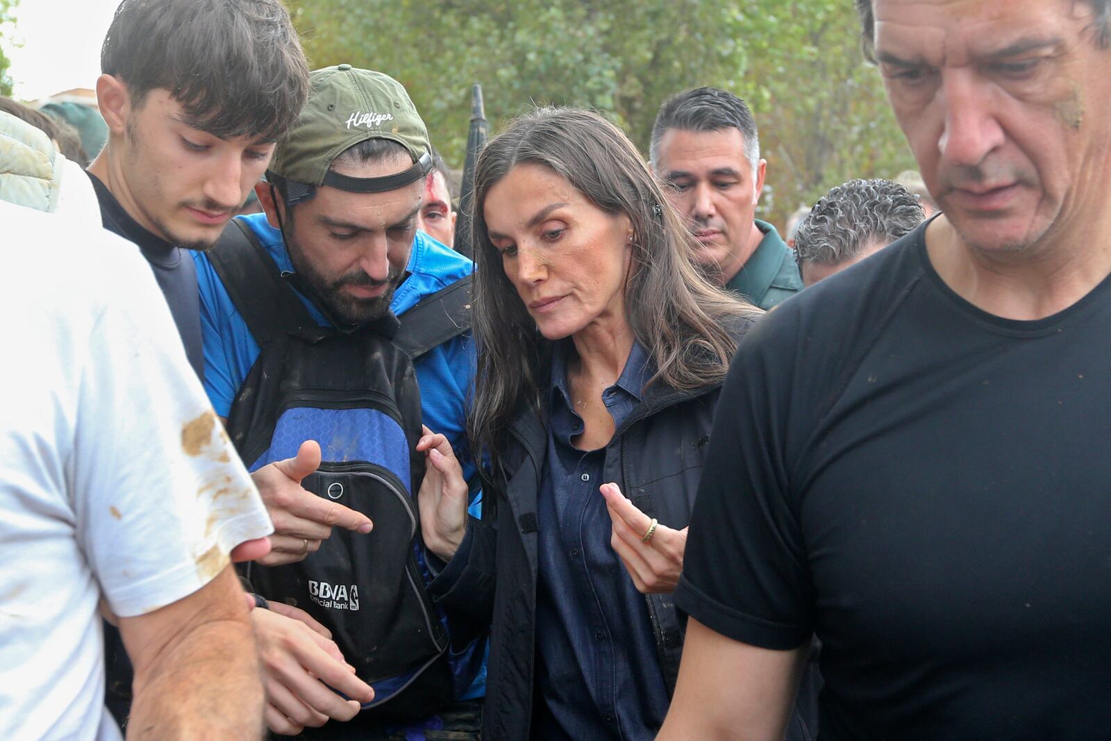 Spain's Queen Letizia speaks with people affected by the floods after crowd of angry survivors of Spain's floods tossed mud and shouted insults at the Spain's King Felipe and government officials when they made their first visit to one of the hardest hit towns. after floods in Paiporta near Valencia, Spain, Sunday, Nov. 3, 2024. (AP Photo/Hugo Torres)