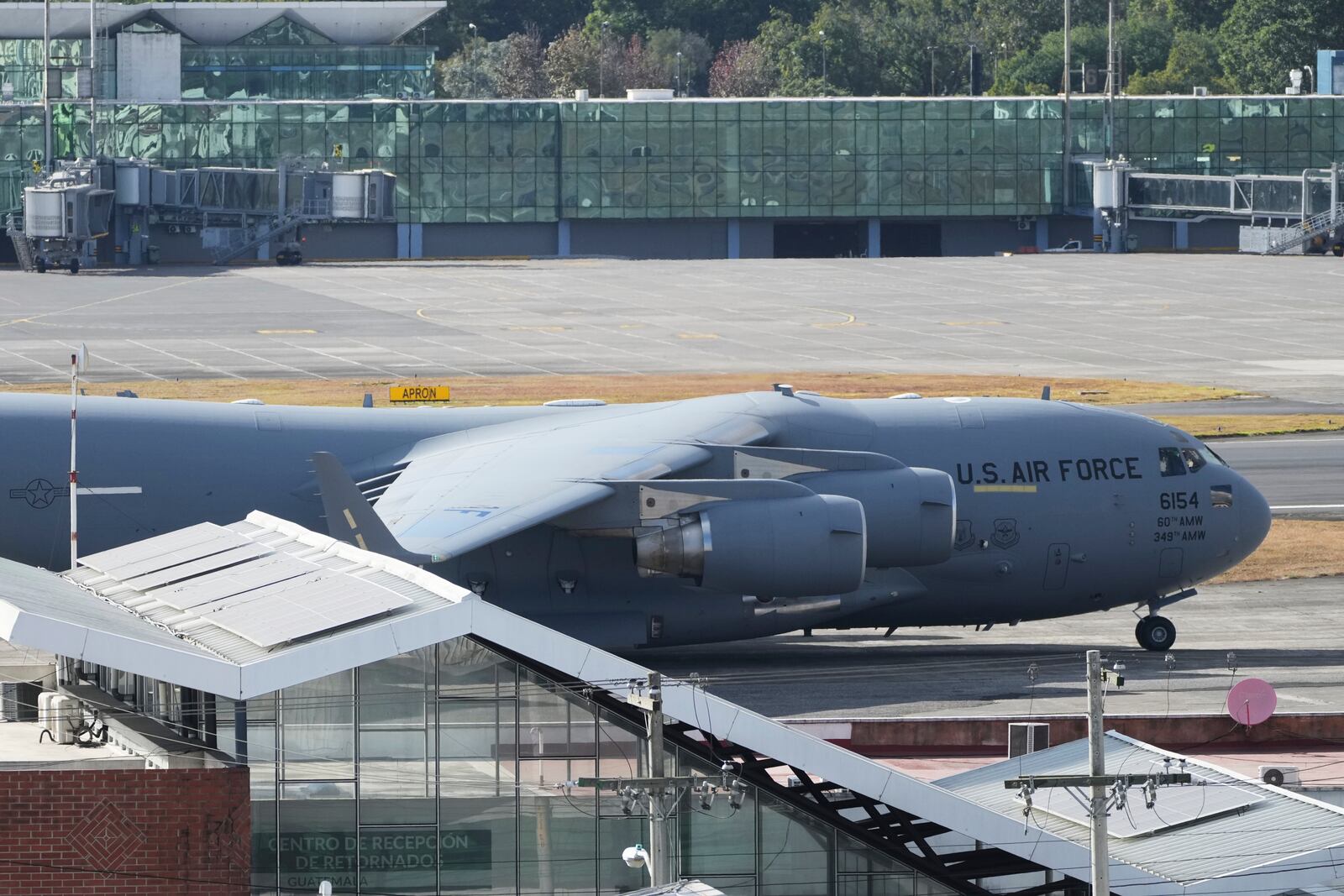 A U.S. military plane carrying Guatemalan migrants deported from the United States sits on the tarmac at La Aurora airport in Guatemala City, Monday, Jan. 27, 2025. (AP Photo/Moises Castillo)