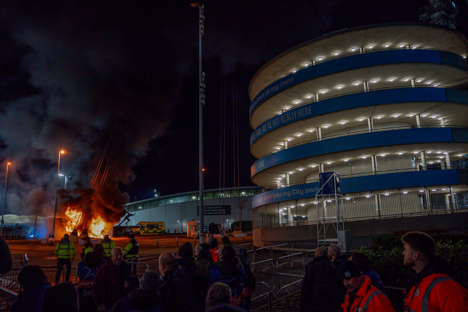 A fire burns at a merchandise kiosk outside the Etihad Stadium before the Champions League opening phase soccer match between Manchester City and Brugge in Manchester, England, Wednesday, Jan. 29, 2025.(AP Photo/Dave Thompson)