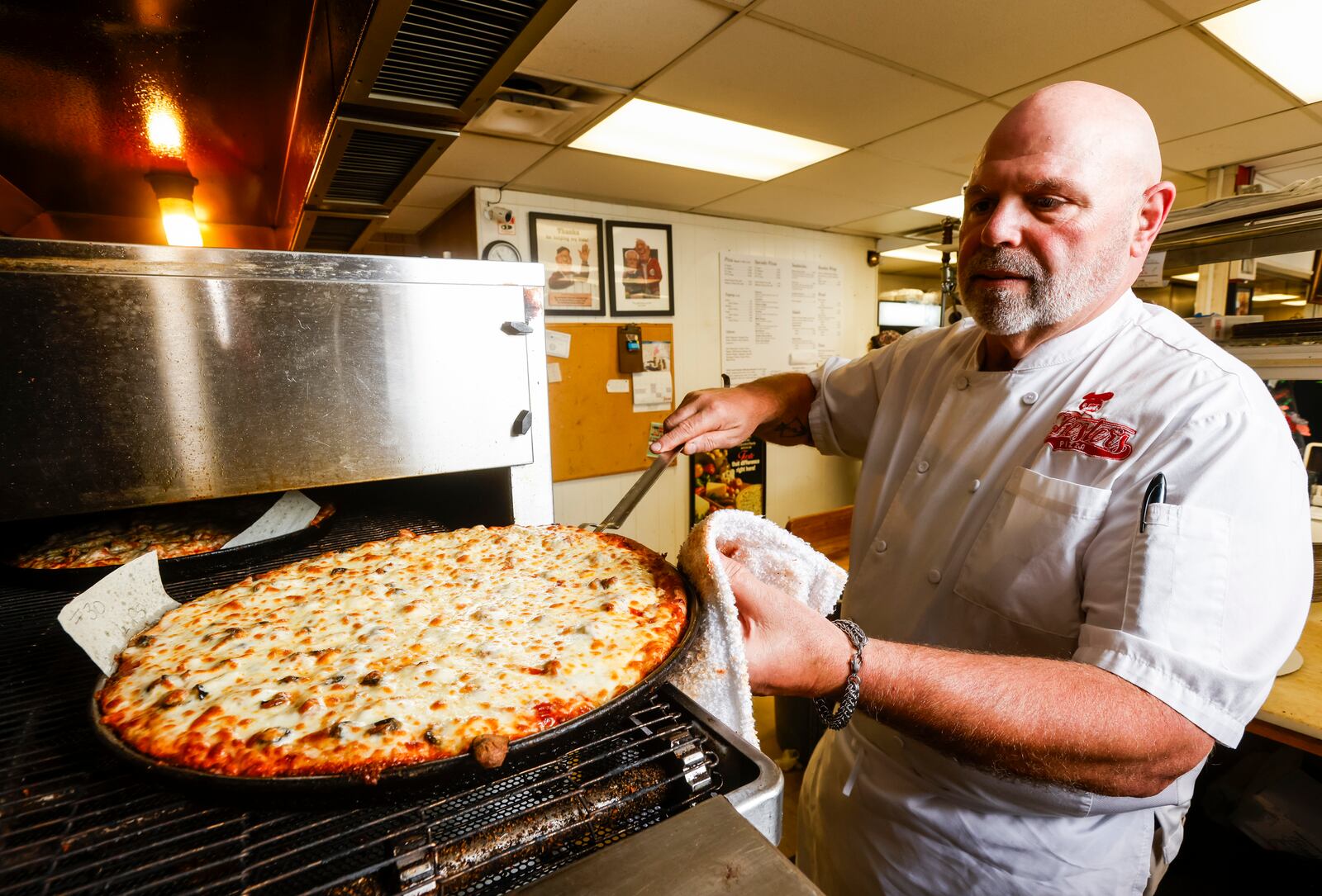 Chuck Vitale prepares a pizza order at Chester's Pizzeria on Dixie Highway in Hamilton Wednesday, June 21, 2023. NICK GRAHAM/STAFF 