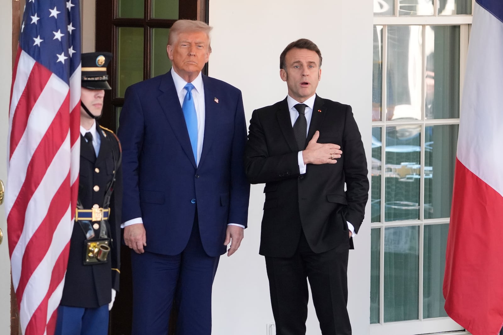 France's President Emmanuel Macron responds to a reporter's question about Pope Francis as President Donald Trump, center, listens before a news conference at the White House, Monday, Feb. 24, 2025, in Washington. (AP Photo/Manuel Balce Ceneta)