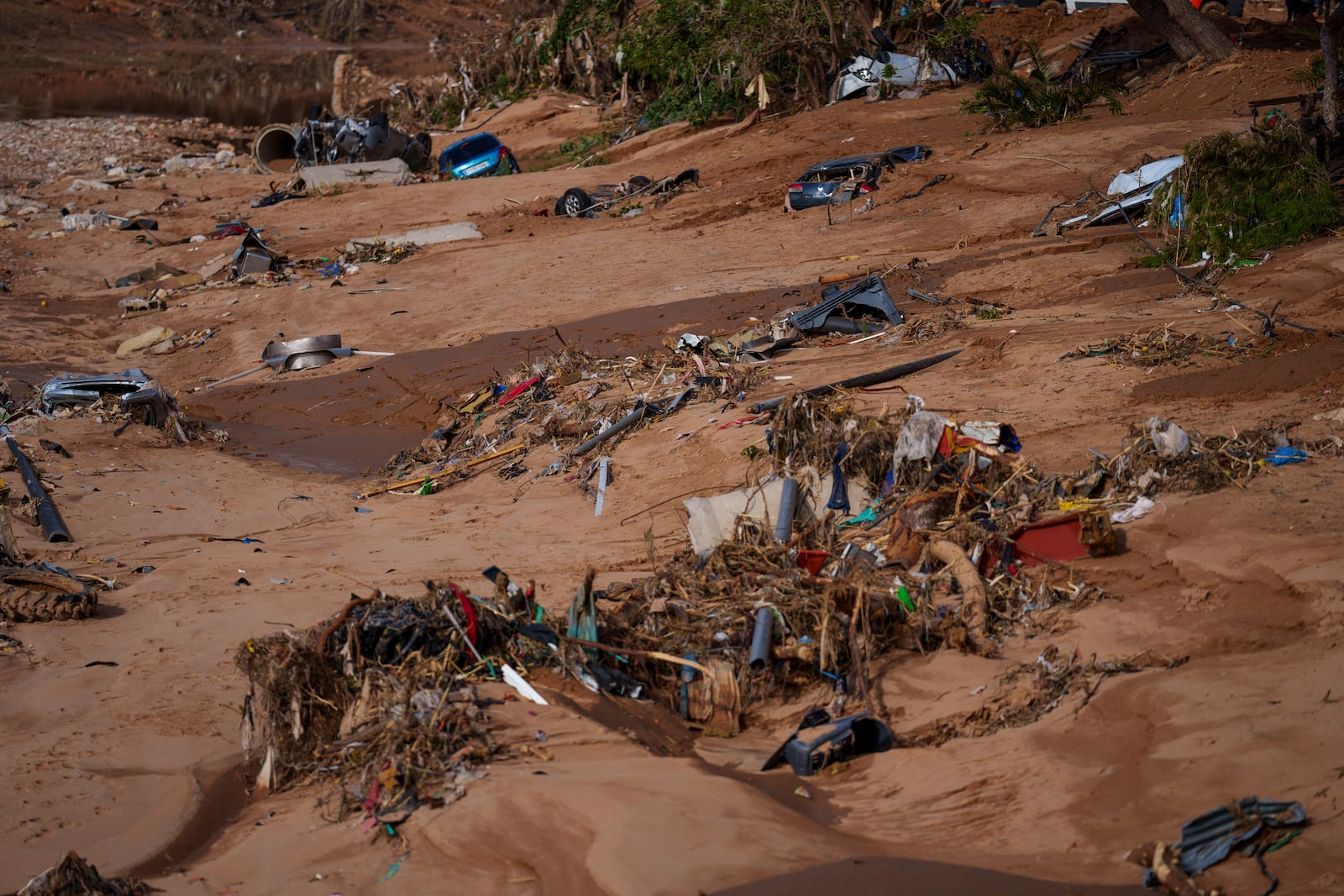 Cars remain submerged in mud in an area affected by floods in Valencia, Spain, Saturday, Nov. 2, 2024. (AP Photo/Manu Fernandez)