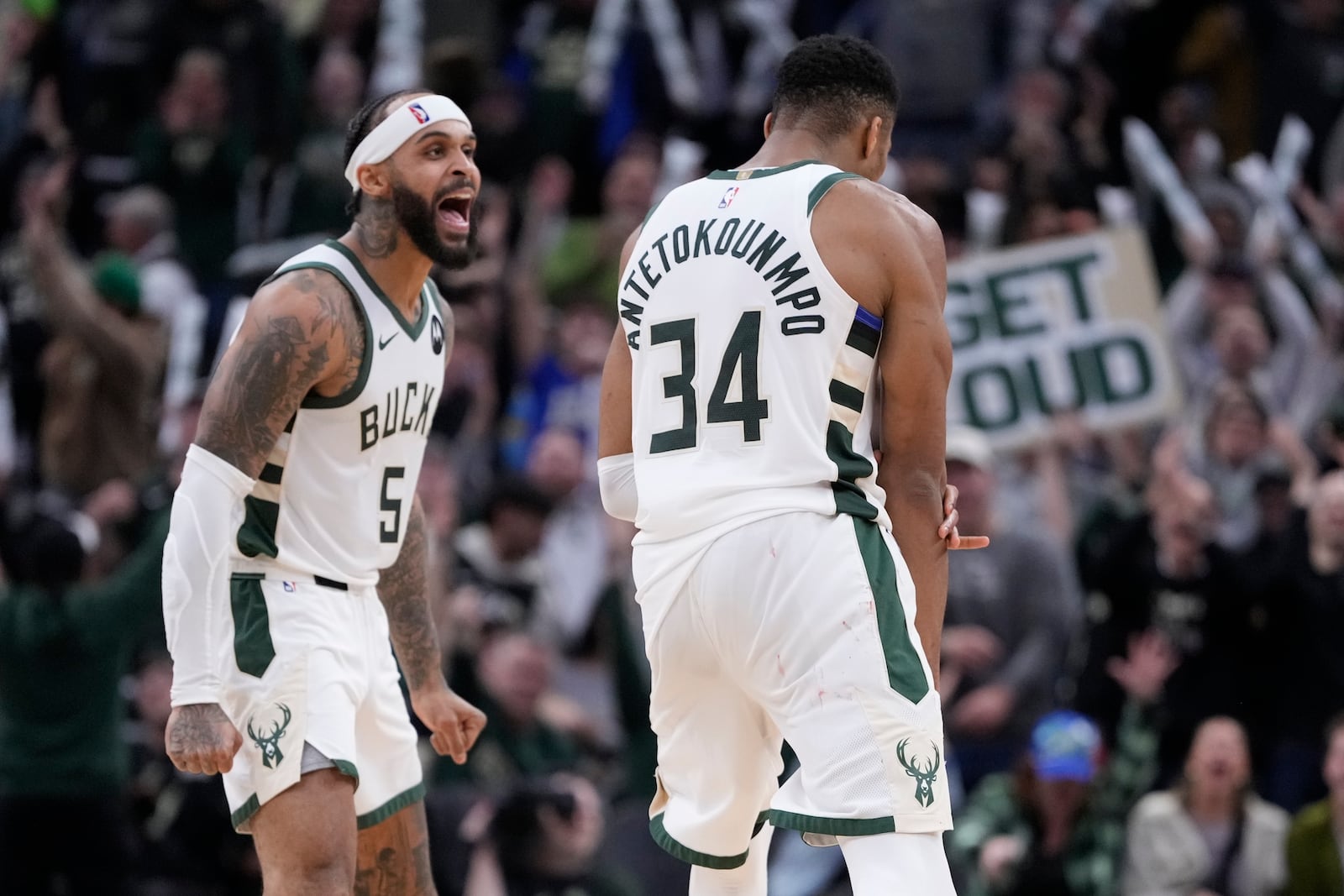 Milwaukee Bucks' Giannis Antetokounmpo celebrates with Gary Trent Jr. during overtime of an NBA basketball game against the Detroit Pistons Wednesday, Nov. 13, 2024, in Milwaukee. (AP Photo/Morry Gash)