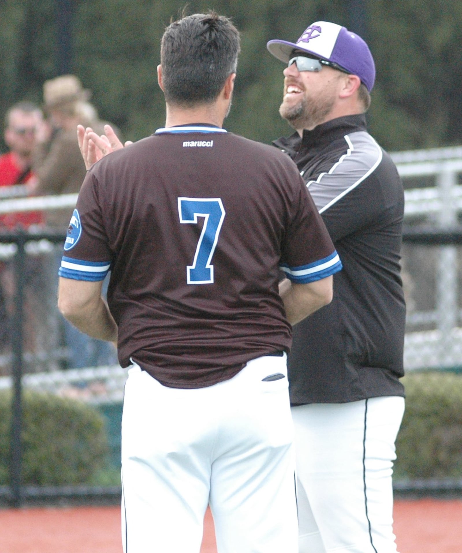 Cincinnati Hills Christian Academy coach Tony Schulz shares a laugh with Cincinnati Christian coach Curtus Moak (7) after Thursday’s Miami Valley Conference baseball game at Prasco Park’s Legacy Field in Mason. CHCA won 3-2. RICK CASSANO/STAFF