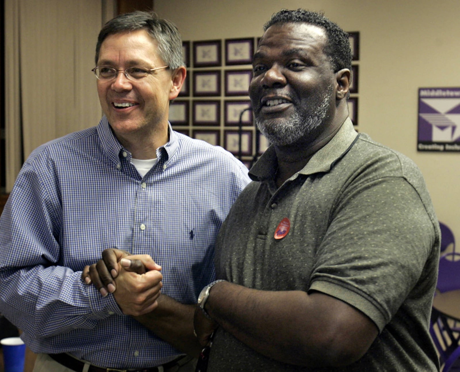 Greg Rasmussen, superintendent for the Middletown City Schools, celebrates the school levy victory with school board member Greg Tyus Tuesday night, May 4, 2010 inside the board offices in Middletown, Ohio.