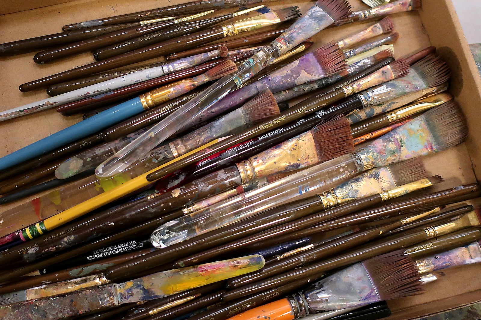 Artist Phyllis Garibay-Coon, of Manhattan, Kansas, used a wide variety of brushes to the Statehouse to touch up her mural honoring Kansas women who campaign for voting rights for decades starting in the 1850s, Tuesday, Jan. 28, 2025, in Topeka, Kan. (AP Photo/John Hanna)