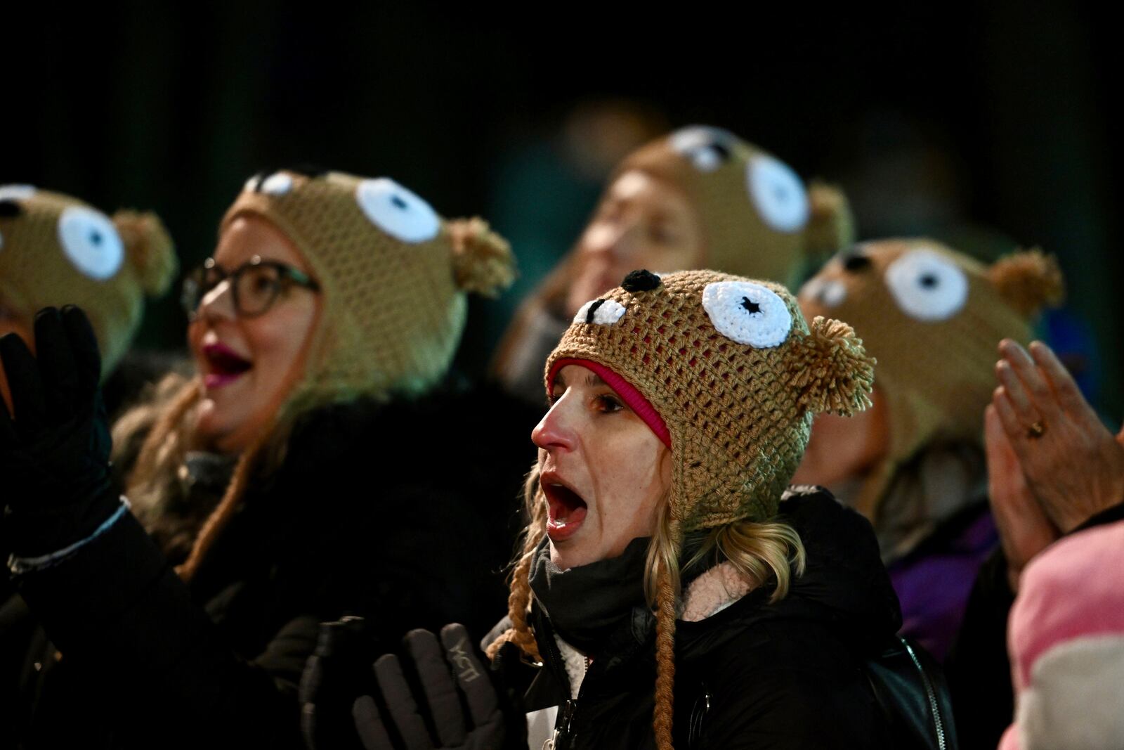 FILE - Ashley Johnson of Dallas watches entertainment while waiting for Punxsutawney Phil, the weather prognosticating groundhog, to come out and make his prediction during the 136th celebration of Groundhog Day on Gobbler's Knob in Punxsutawney, Pa., Wednesday, Feb. 2, 2022. (AP Photo/Barry Reeger, File)