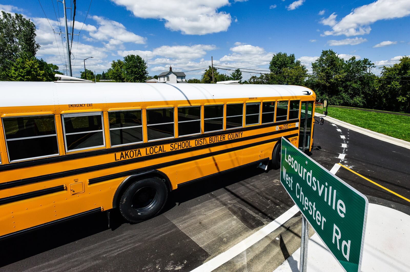 A Lakota school bus drives around the roundabout at LeSourdsville West Chester Road and Beckett Road in West Chester Township Wednesday, August 19, 2020. This is the most recent roundabout to be competed in Butler County. NICK GRAHAM / STAFF