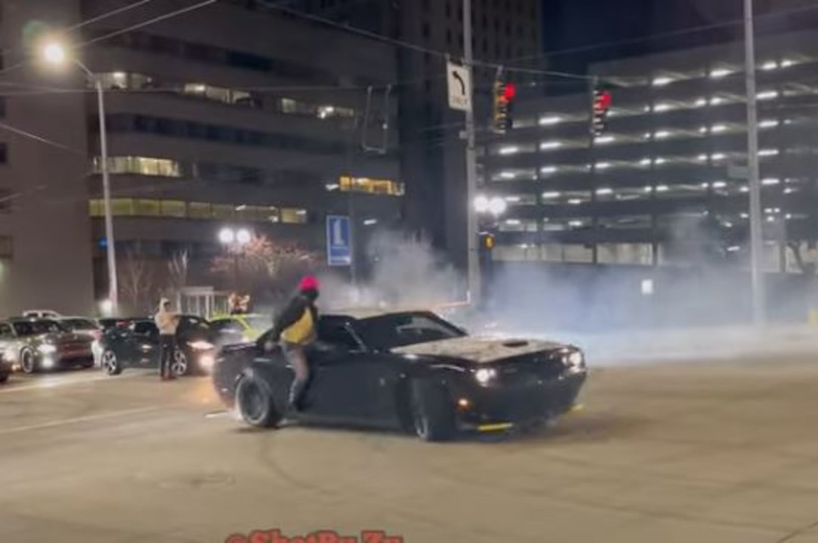 Cars do donuts and drive in circles at the intersection of East Third Street and South Jefferson Street on Sunday morning. YOUTUBE