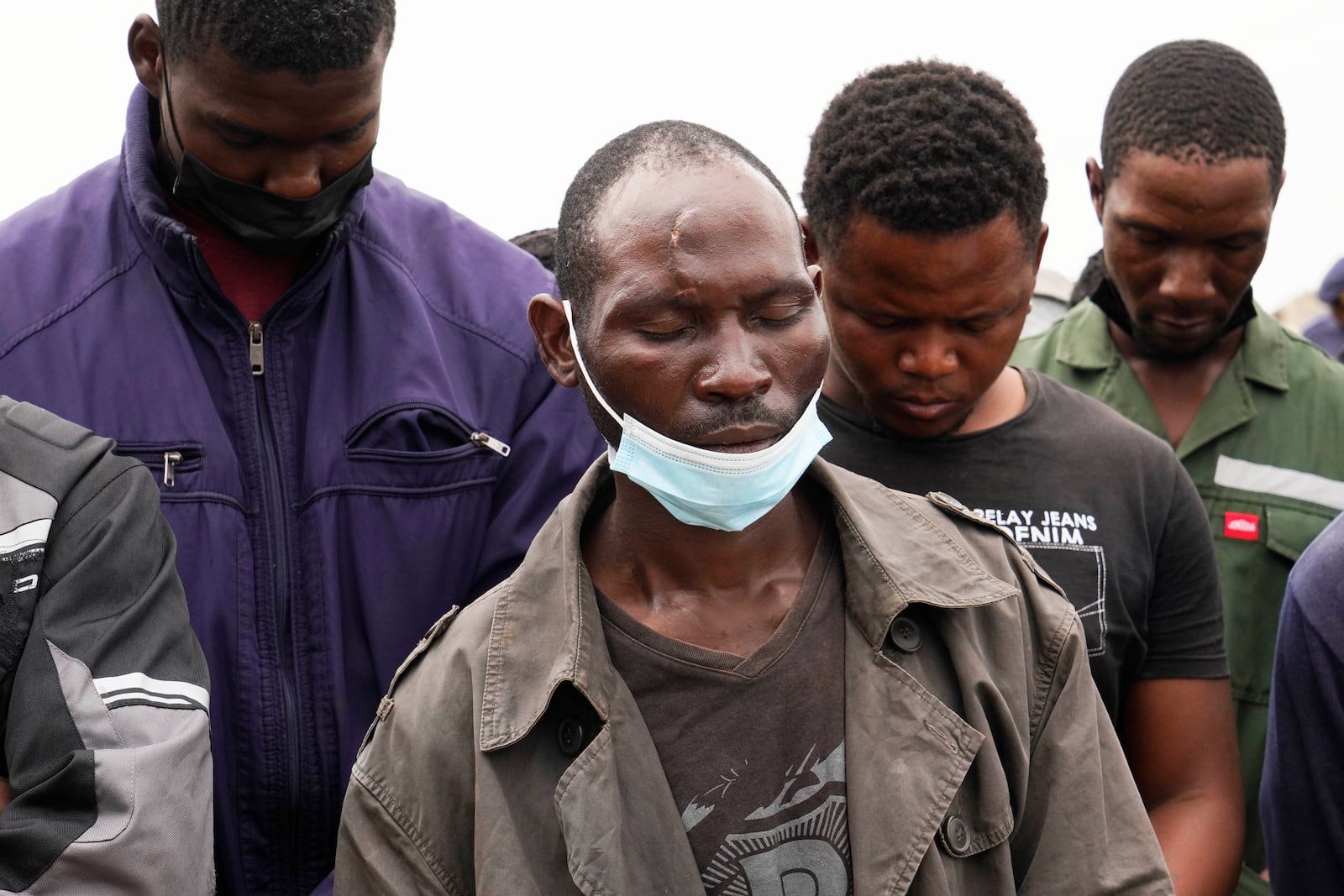 Volunteer rescue workers stand by the opening of a reformed gold mine shaft where illegal miners are trapped in Stilfontein, South Africa, Friday, Nov. 15, 2024. (AP Photo/Denis Farrell)