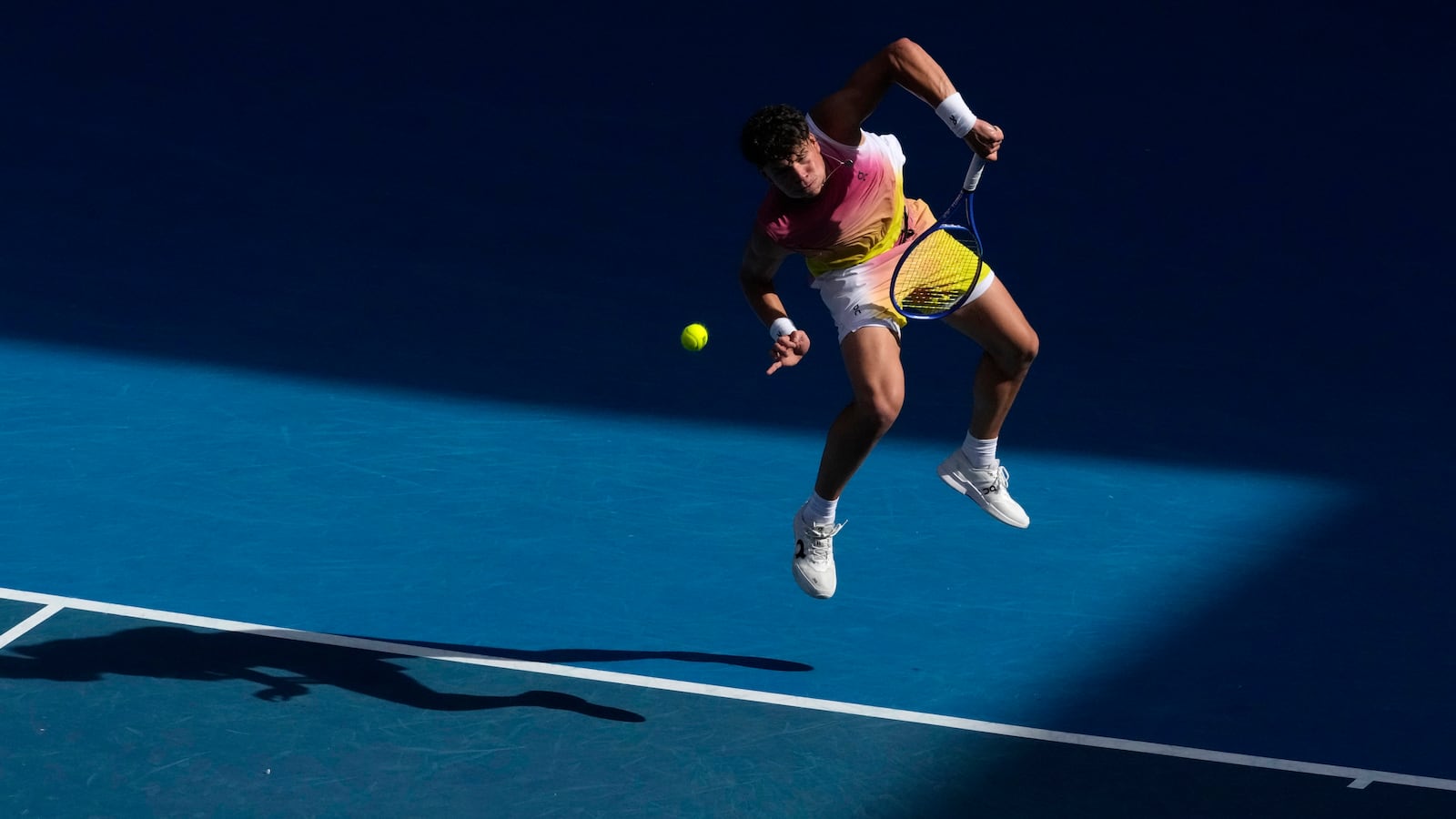 Ben Shelton of the U.S. serves to Gael Monfils of France during their fourth round match at the Australian Open tennis championship in Melbourne, Australia, Monday, Jan. 20, 2025. (AP Photo/Manish Swarup)