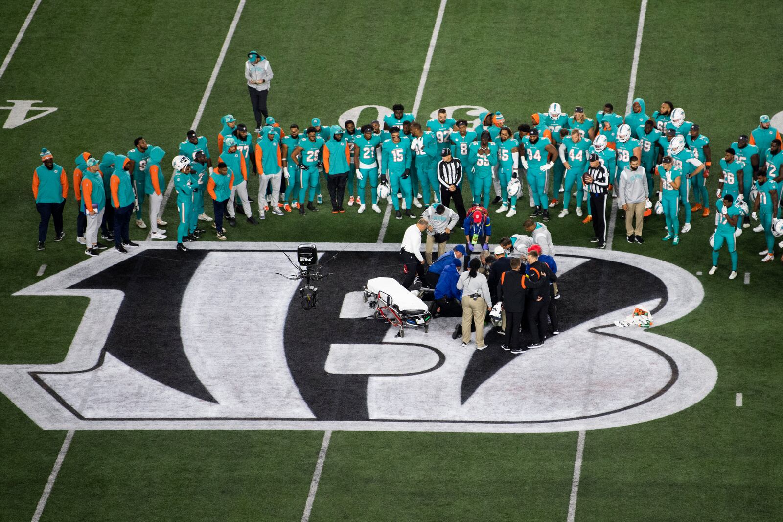 Teammates gather around Miami Dolphins quarterback Tua Tagovailoa (1) after an injury during the first half of an NFL football game against the Cincinnati Bengals, Thursday, Sept. 29, 2022, in Cincinnati. (AP Photo/Emilee Chinn)