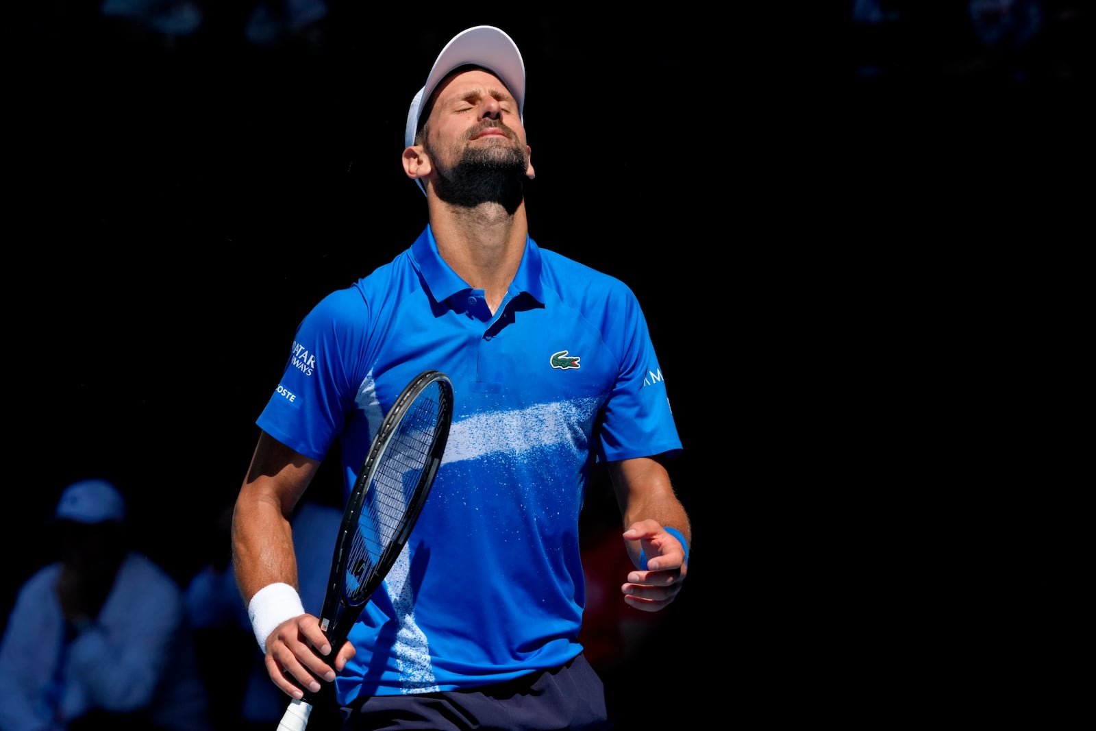 Novak Djokovic of Serbia reacts during his semifinal match against Alexander Zverev of Germany at the Australian Open tennis championship in Melbourne, Australia, Friday, Jan. 24, 2025. (AP Photo/Manish Swarup)