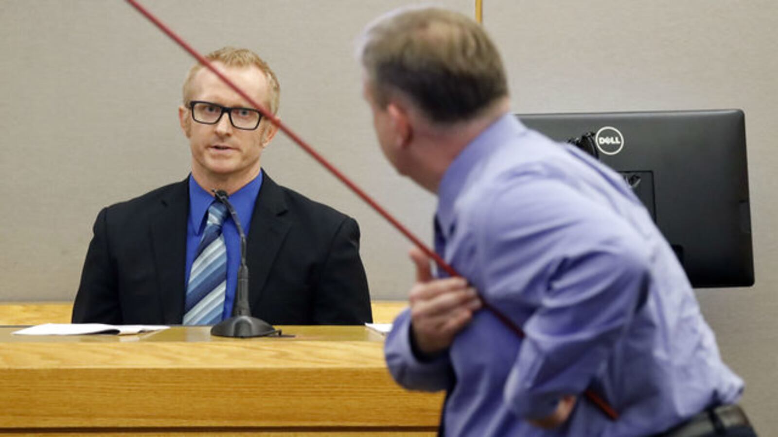 Dallas County medical examiner Dr. Chester Gwin, left, testifies Wednesday, Sept. 25, 2019, as prosecutor Jason Hermus demonstrates the path a bullet took in Botham Jean's body. Ex-Dallas police officer Amber Guyger is on trial for Jean's murder.