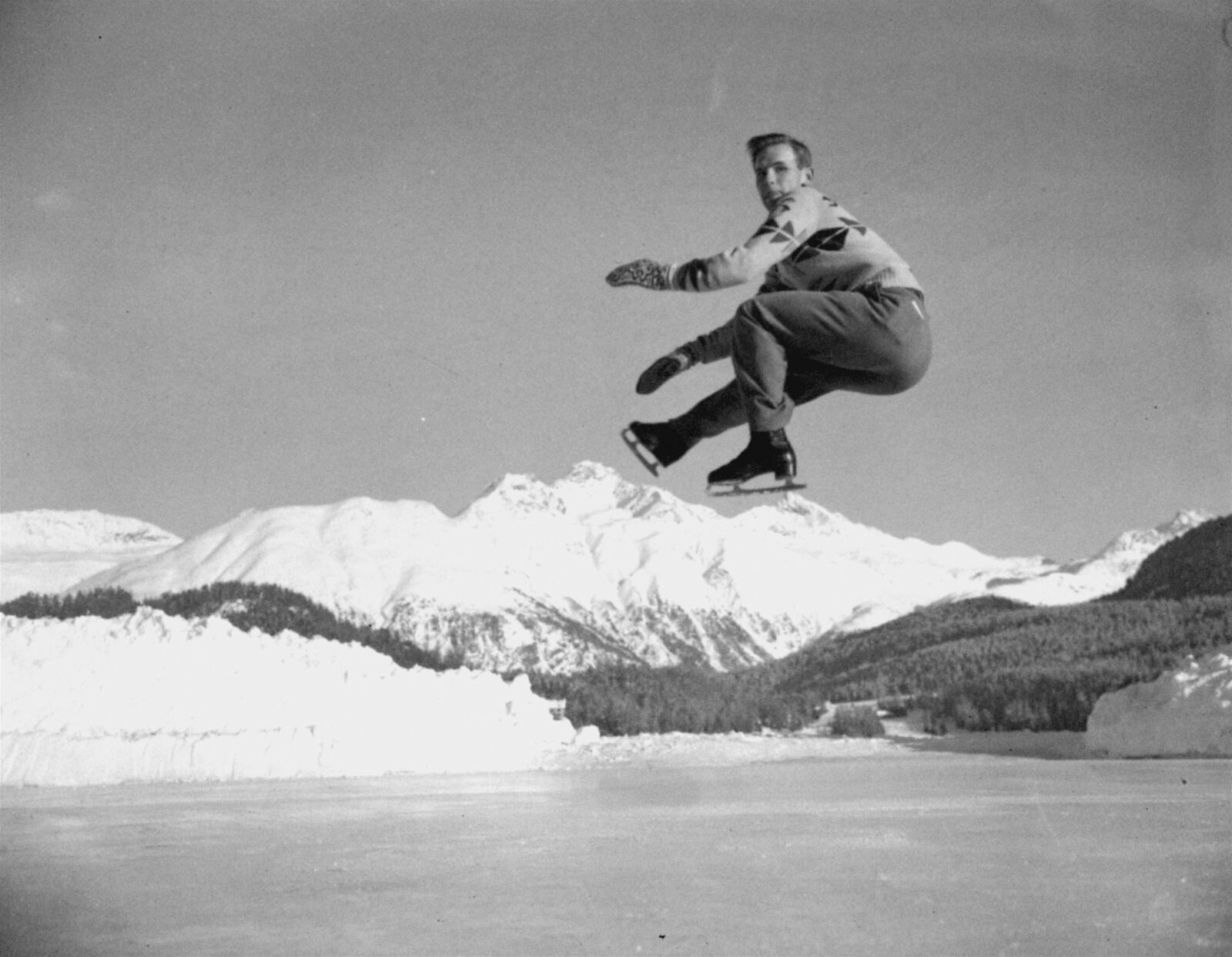 FILE - Dick Button of Englewood, N.J., U.S. and North American men's figure skating champion, and winner of the European title, executes a jump during a practice session at St. Moritz, Switzerland, on Jan. 19, 1948, in preparation for the Winter Olympics of 1948. (AP Photo, File)