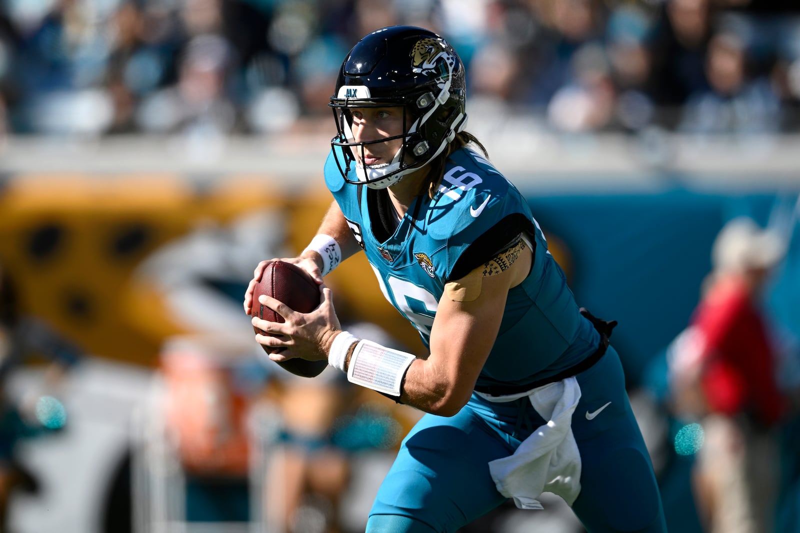 FILE - Jacksonville Jaguars quarterback Trevor Lawrence (16) scrambles for yardage against the Houston Texans during the first half of an NFL football game, Sunday, Dec. 1, 2024, in Jacksonville, Fla. (AP Photo/Phelan M. Ebenhack, File)