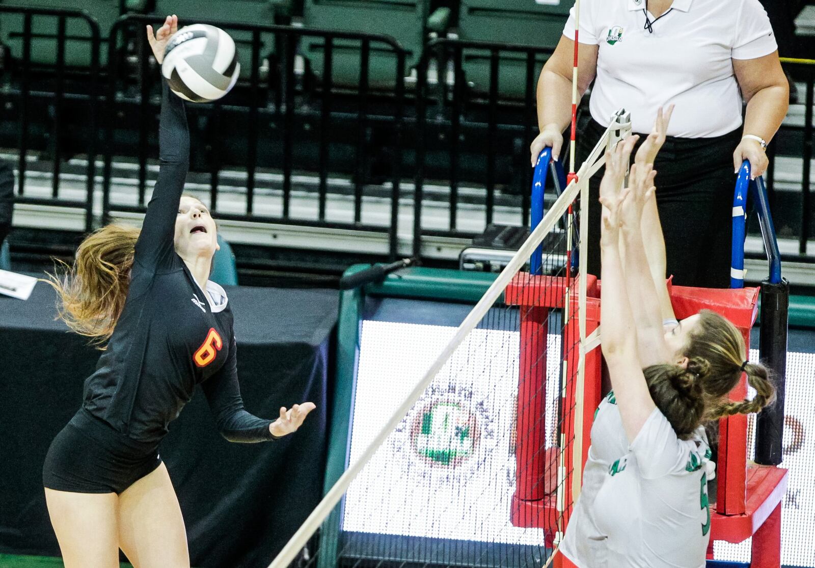 Fenwick’s Grace Dinkelaker elevates to spike the ball during Friday’s Division II state volleyball semifinal against Parma Heights Holy Name at Wright State University’s Nutter Center. NICK GRAHAM/STAFF