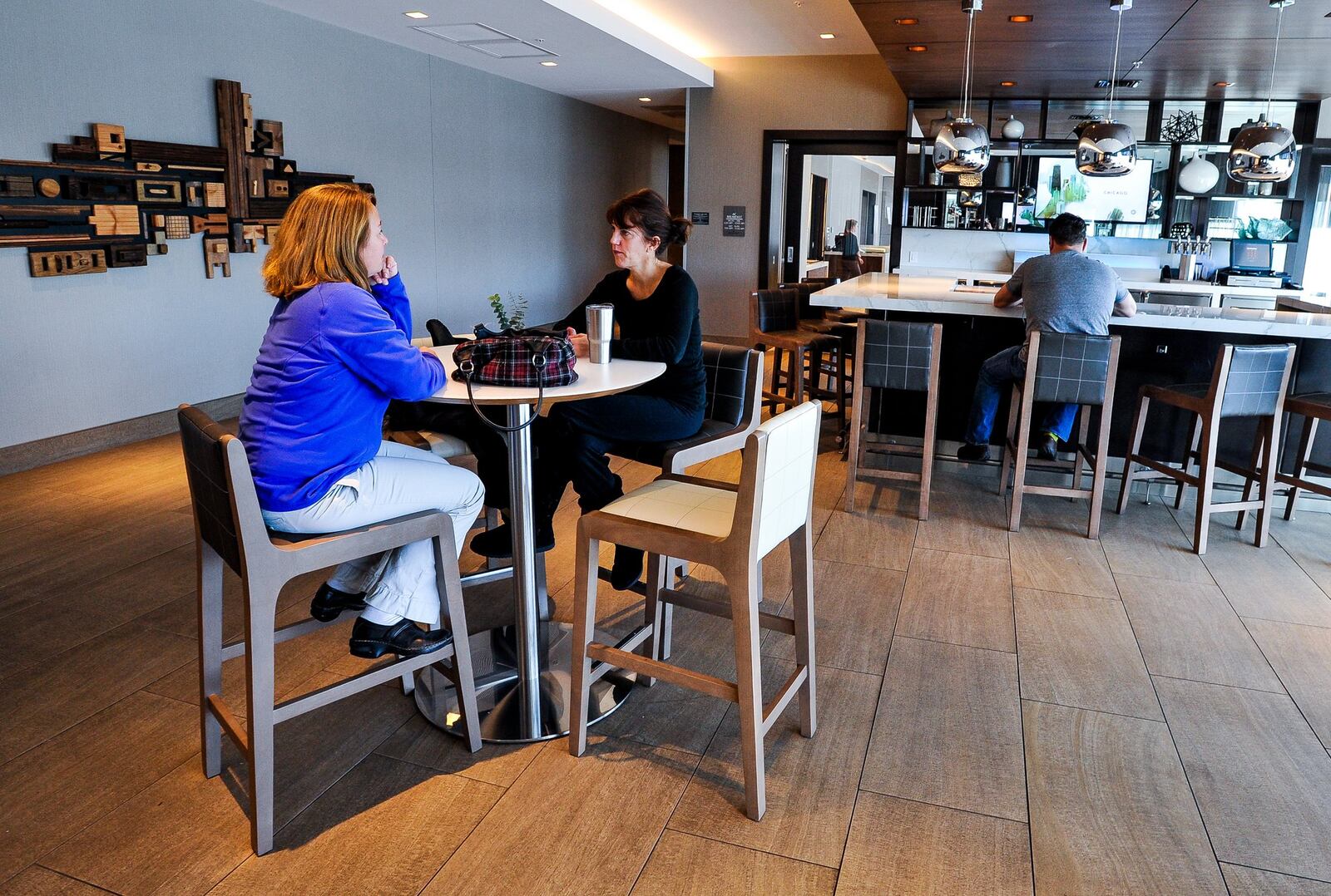 Hotel patrons make use of the breakfast and bar area Dec. 30 at AC Hotel at Liberty Center in Liberty Twp. The hotel industry is surging in Butler County suburbs of West Chester and Liberty townships. NICK GRAHAM/STAFF