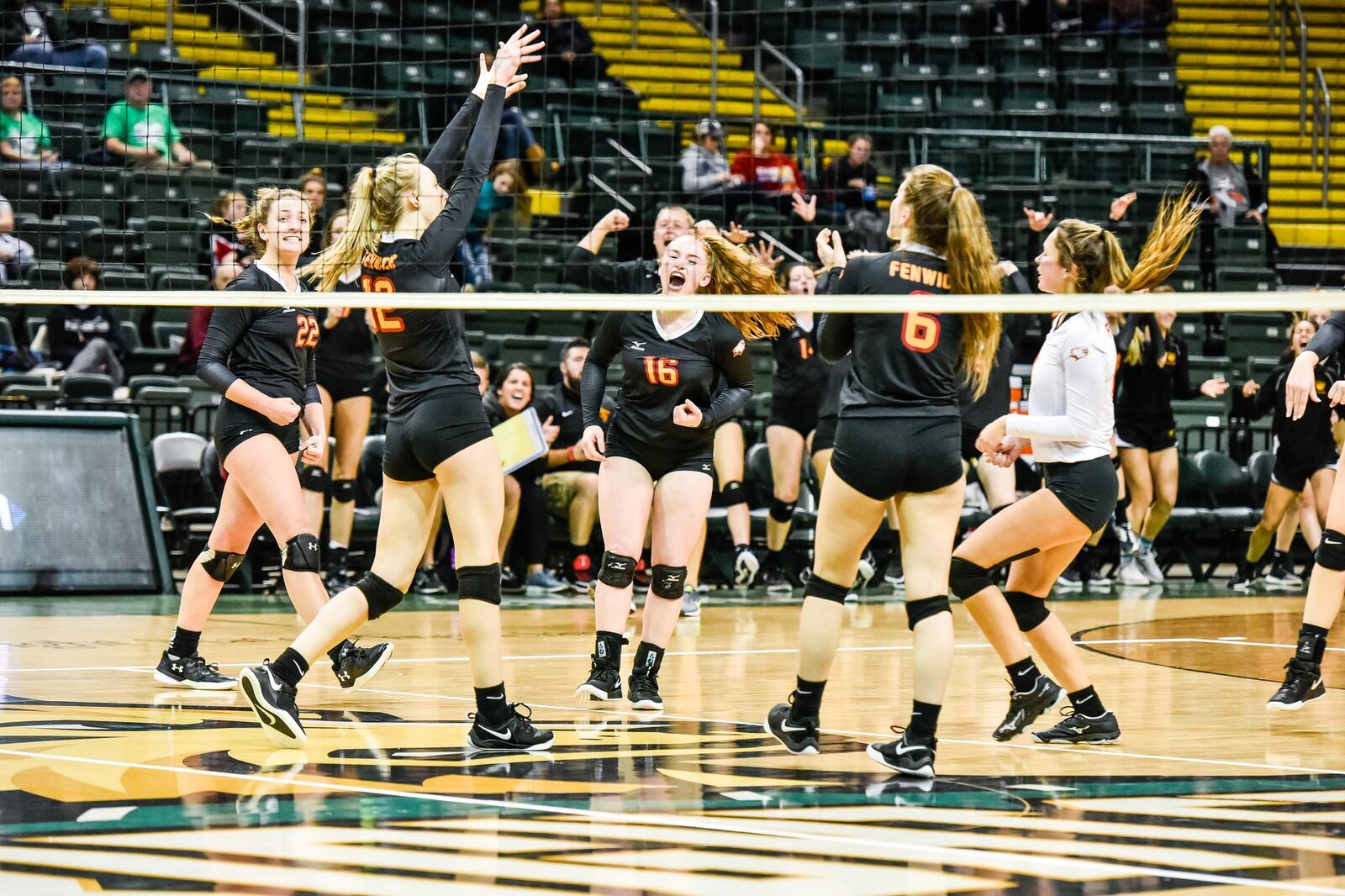 Fenwick’s players celebrate a point Friday during a Division II state volleyball semifinal against Parma Heights Holy Name at Wright State University’s Nutter Center. NICK GRAHAM/STAFF