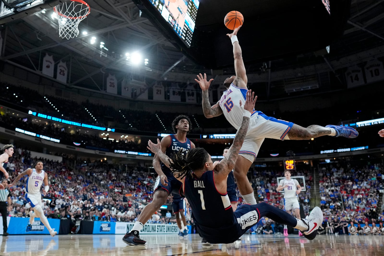 Florida guard Alijah Martin shoots over UConn guard Solo Ball during the second half in the second round of the NCAA college basketball tournament, Sunday, March 23, 2025, in Raleigh, N.C. (AP Photo/Chris Carlson)