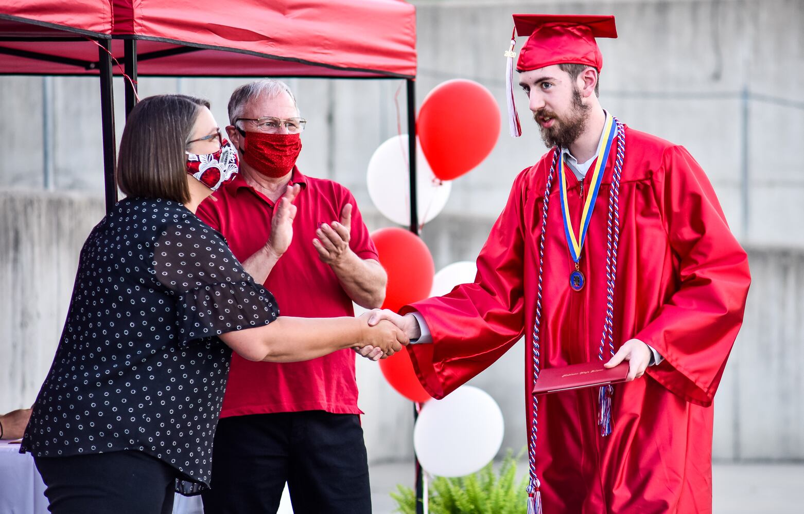 Madison High School drive-thru graduation ceremony at Land of Illusion