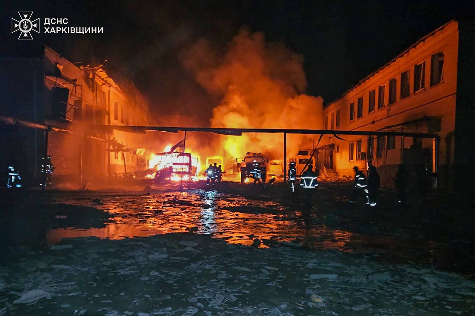 In this photo provided by the Ukrainian Emergency Service, fire engines burn after a Russian drone hit them when firefighters were putting out a fire at a lyceum following Russian drone attack in Bohodukhiv, Kharkiv region, Ukraine, Saturday, March 15, 2025. (Ukrainian Emergency Service via AP)