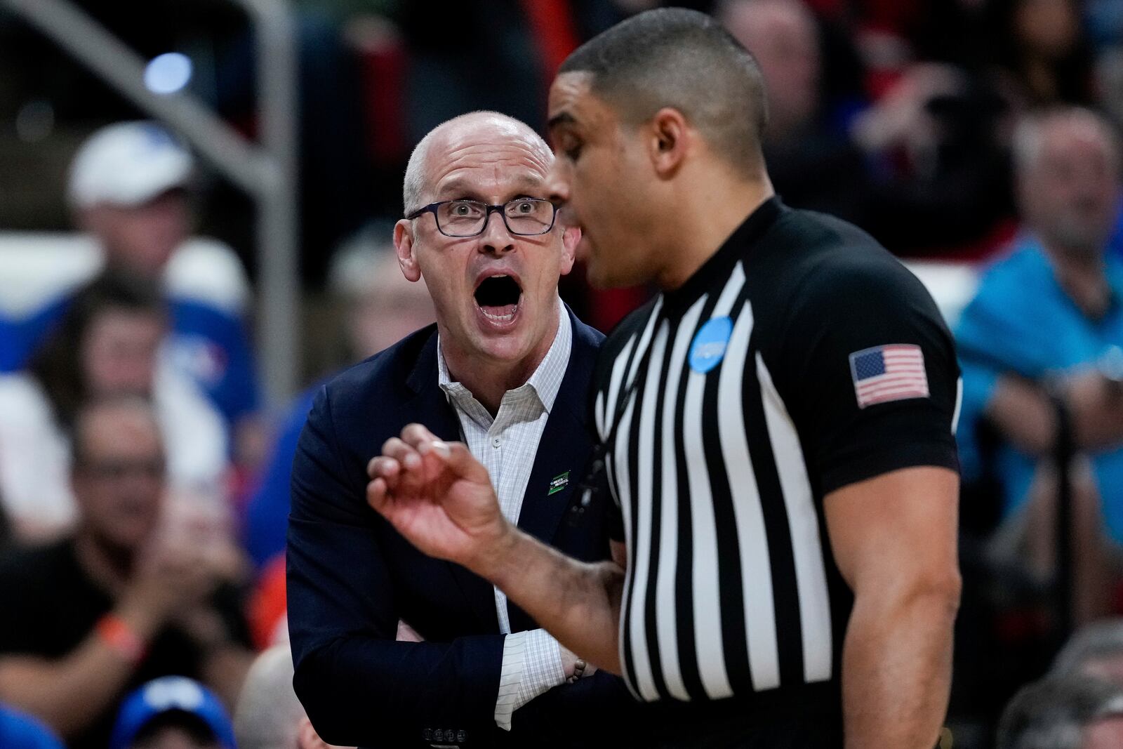 Connecticut head coach Dan Hurley, left, reacts to a call by referees during the first half in the second round of the NCAA college basketball tournament against Florida, Sunday, March 23, 2025, in Raleigh, N.C. (AP Photo/Stephanie Scarbrough)