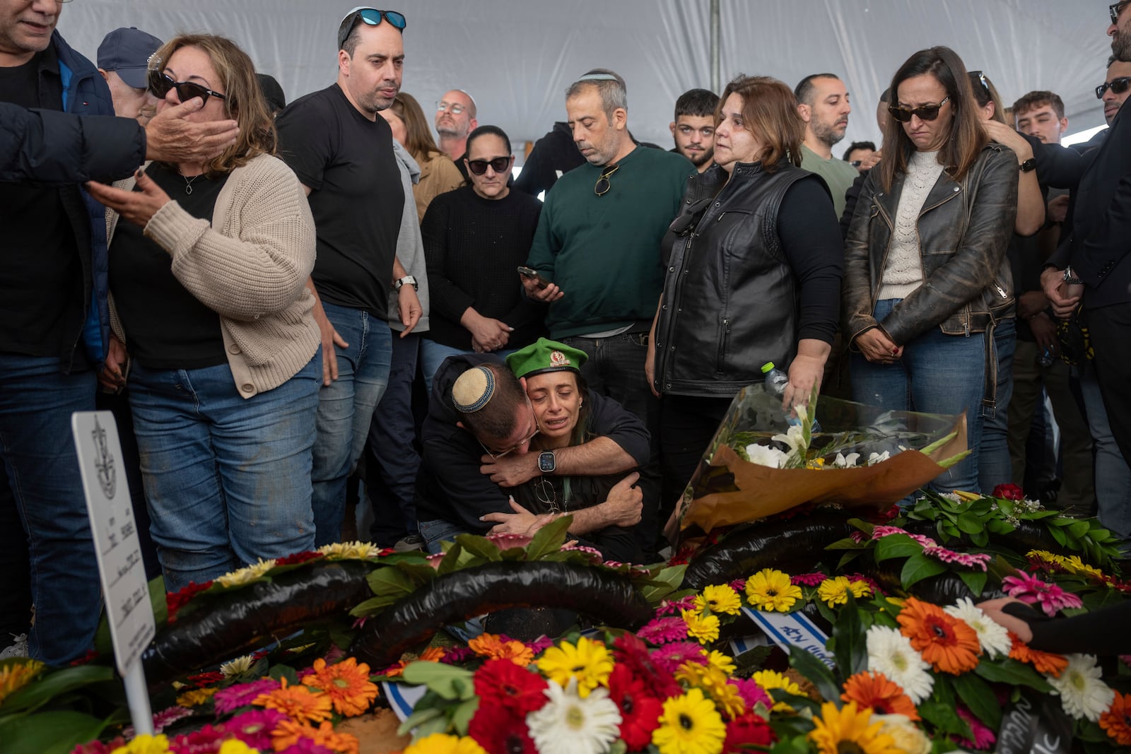 Gali the mother of the Israeli soldier Sergeant Yahav Maayan who was killed in combat in the Gaza Strip, reacts next to his son's grave during his funeral at a military cemetery in Modiin, Israel, Sunday, Jan. 12, 2025. (AP Photo/Ohad Zwigenberg)