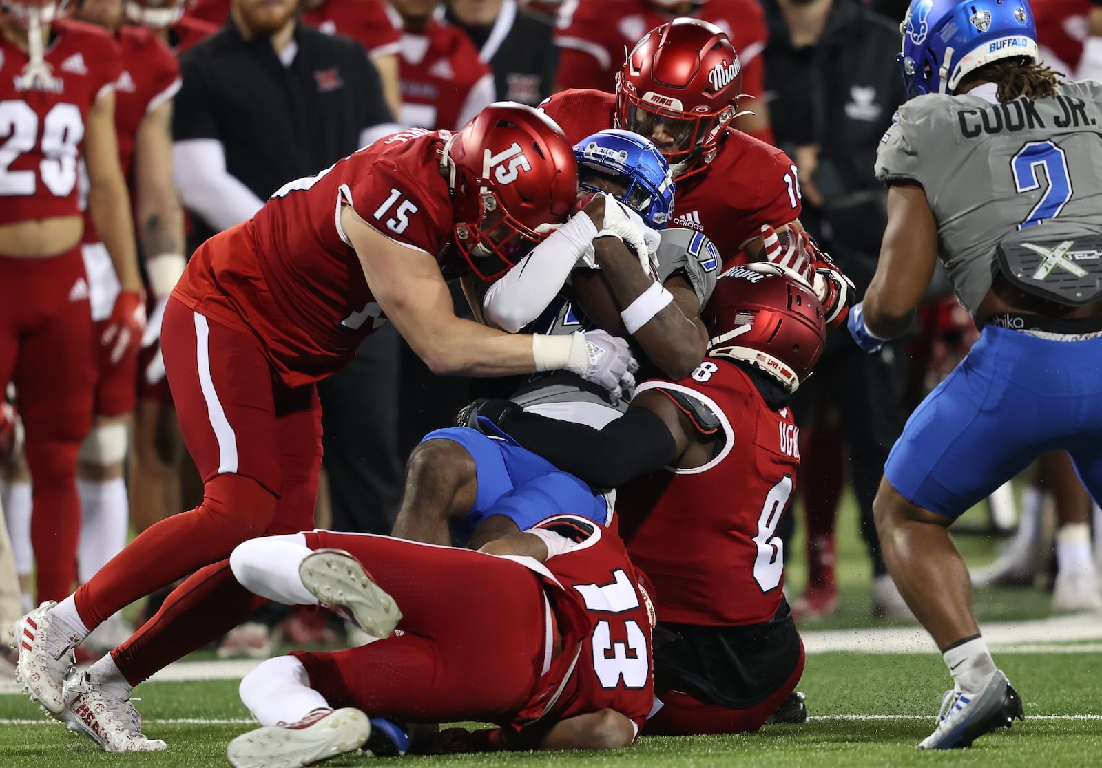 Miami defenses Matthew Salopek (15), Brian Ugwu (8), Raion Strader (13) and Ty Wise (10) tackle Buffalo's Nik McMillan at Yager Stadium on Nov. 15, 2023. Miami Athletics photo