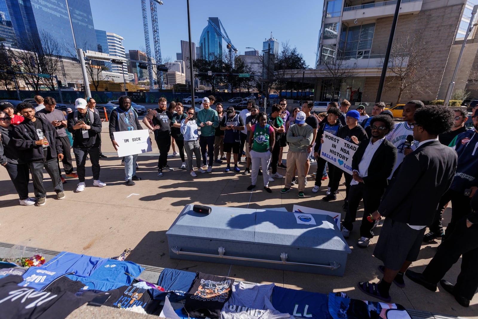 Dozens of fans gather near a coffin and tribute to Dallas Mavericks' Luka Doncic as they take a moment of silence outside the American Airlines Center after Doncic was traded to the Los Angeles Lakers, Sunday, Feb. 2, 2025, in Dallas. (Elias Valverde II/The Dallas Morning News via AP)