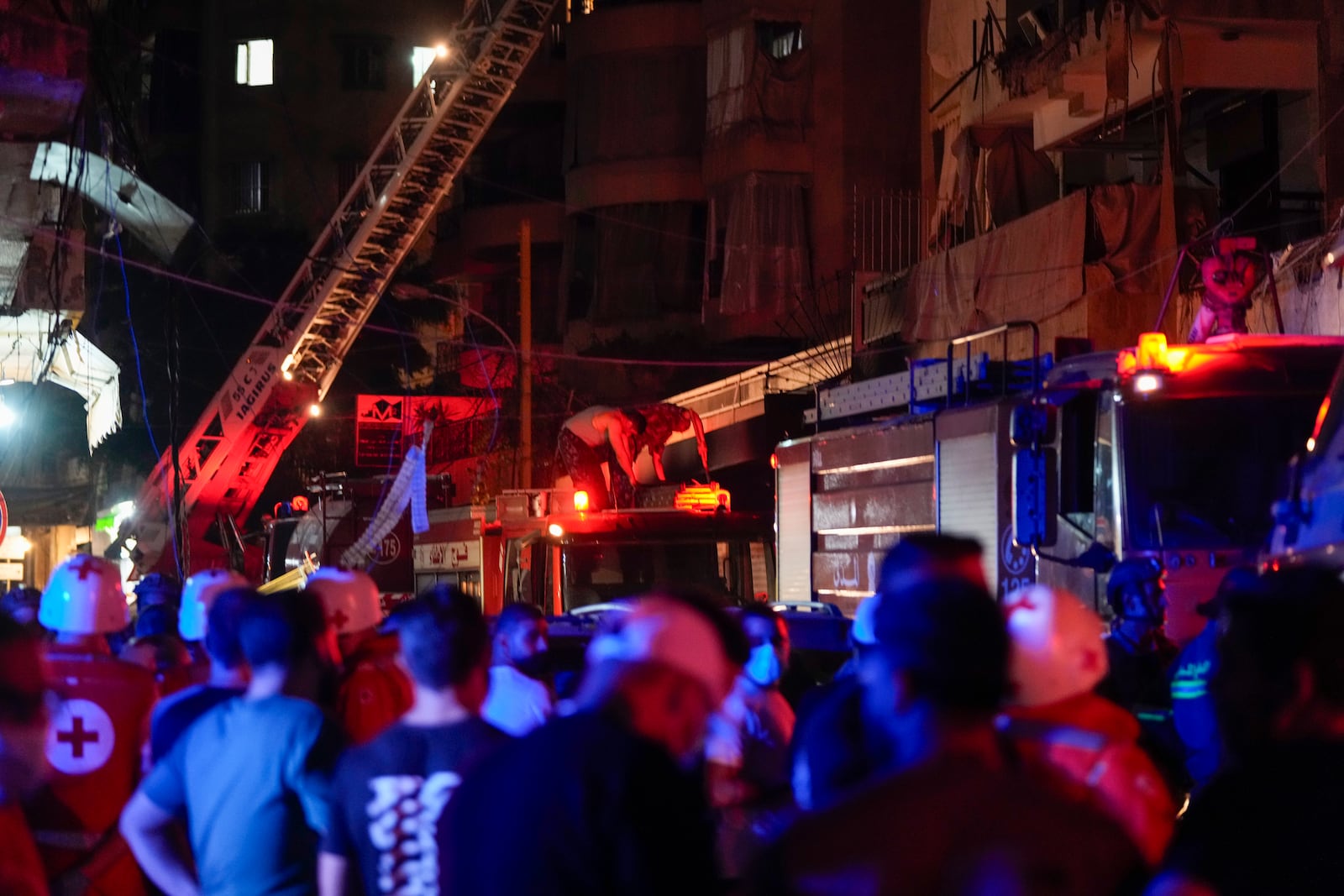 Paramedics and rescue workers work at the site of an Israeli airstrike in Beirut, Lebanon, Thursday, Oct. 10, 2024. (AP Photo/Hassan Ammar)