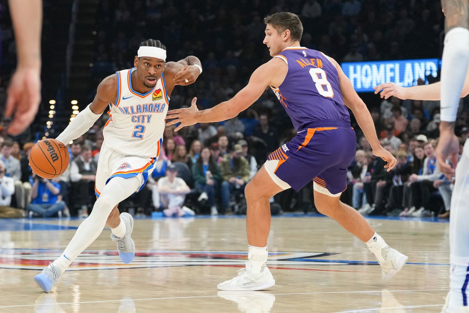 Oklahoma City Thunder guard Shai Gilgeous-Alexander (2) drives past Phoenix Suns guard Grayson Allen (8) during the first half of an NBA basketball game, Wednesday, Feb. 5, 2025, in Oklahoma City. (AP Photo/Kyle Phillips)