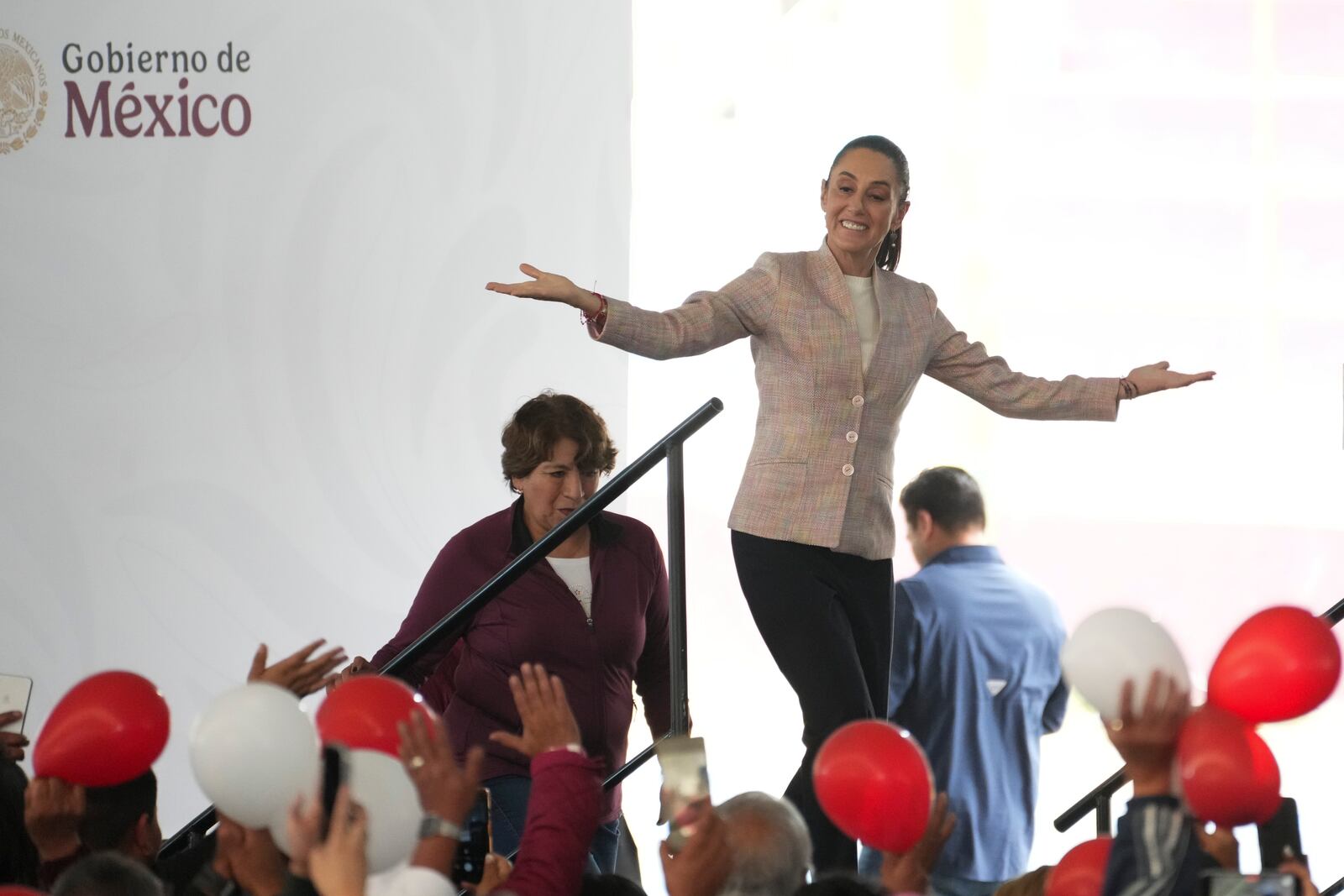 President Claudia Sheinbaum waves as she arrives for a Housing for Wellbeing event, a government-funded home improvement program, in Mexico City, Saturday, Feb. 1, 2025. (AP Photo/Marco Ugarte)