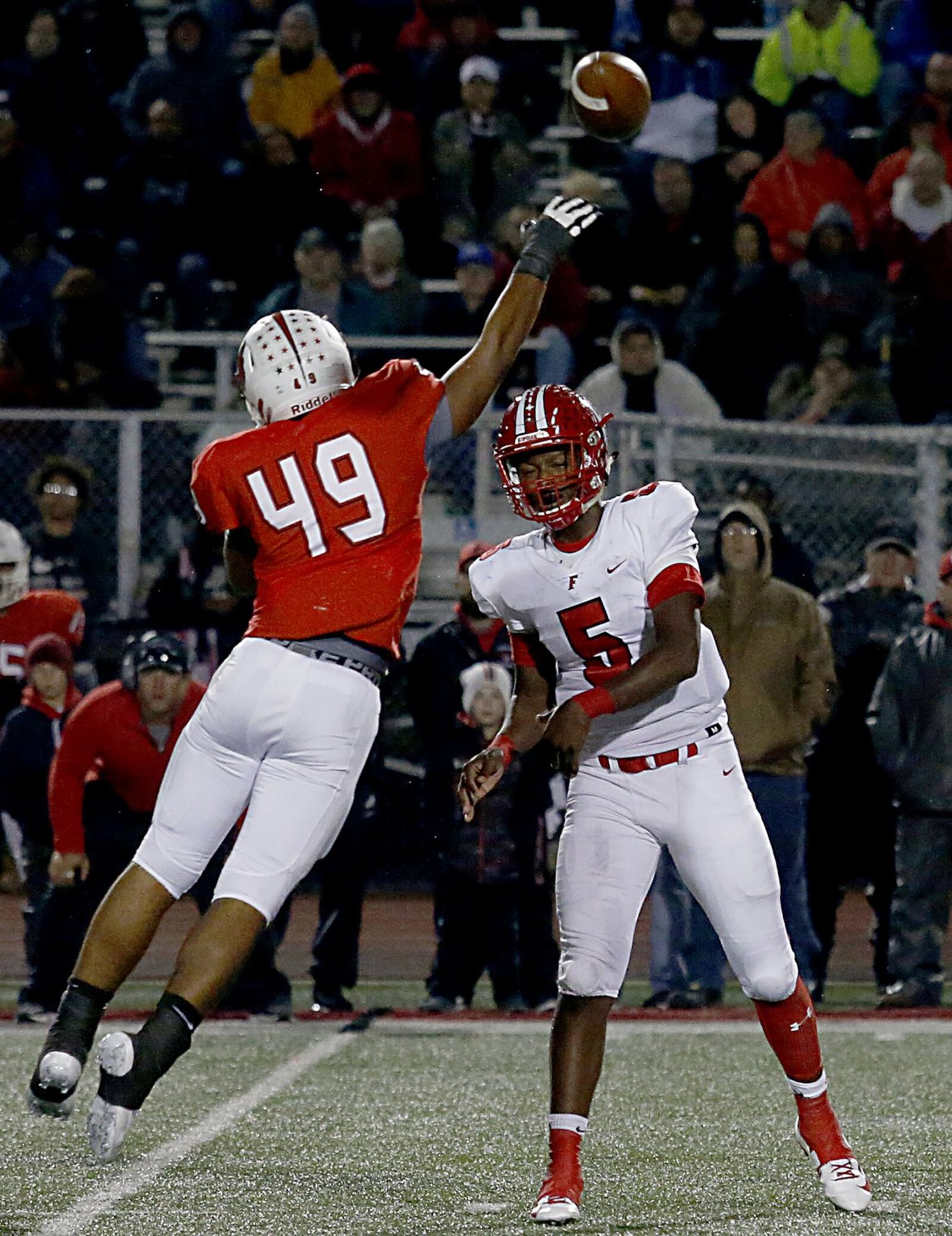 Fairfield quarterback Jeff Tyus passes as Colerain’s Donovan Owens pressures during their game at Cardinal Stadium in Colerain Township on Oct. 19. Colerain won 55-27. CONTRIBUTED PHOTO BY E.L. HUBBARD