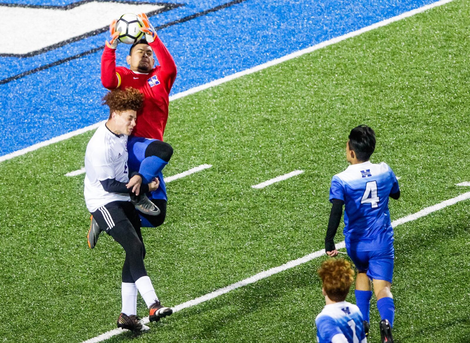 Hamilton goalkeeper Brian Cruz and Middletown’s Kelvin Shealey battle for the ball Monday night at Virgil Schwarm Stadium in Hamilton. Host Big Blue won 4-2 in the Division I sectional opener. NICK GRAHAM/STAFF