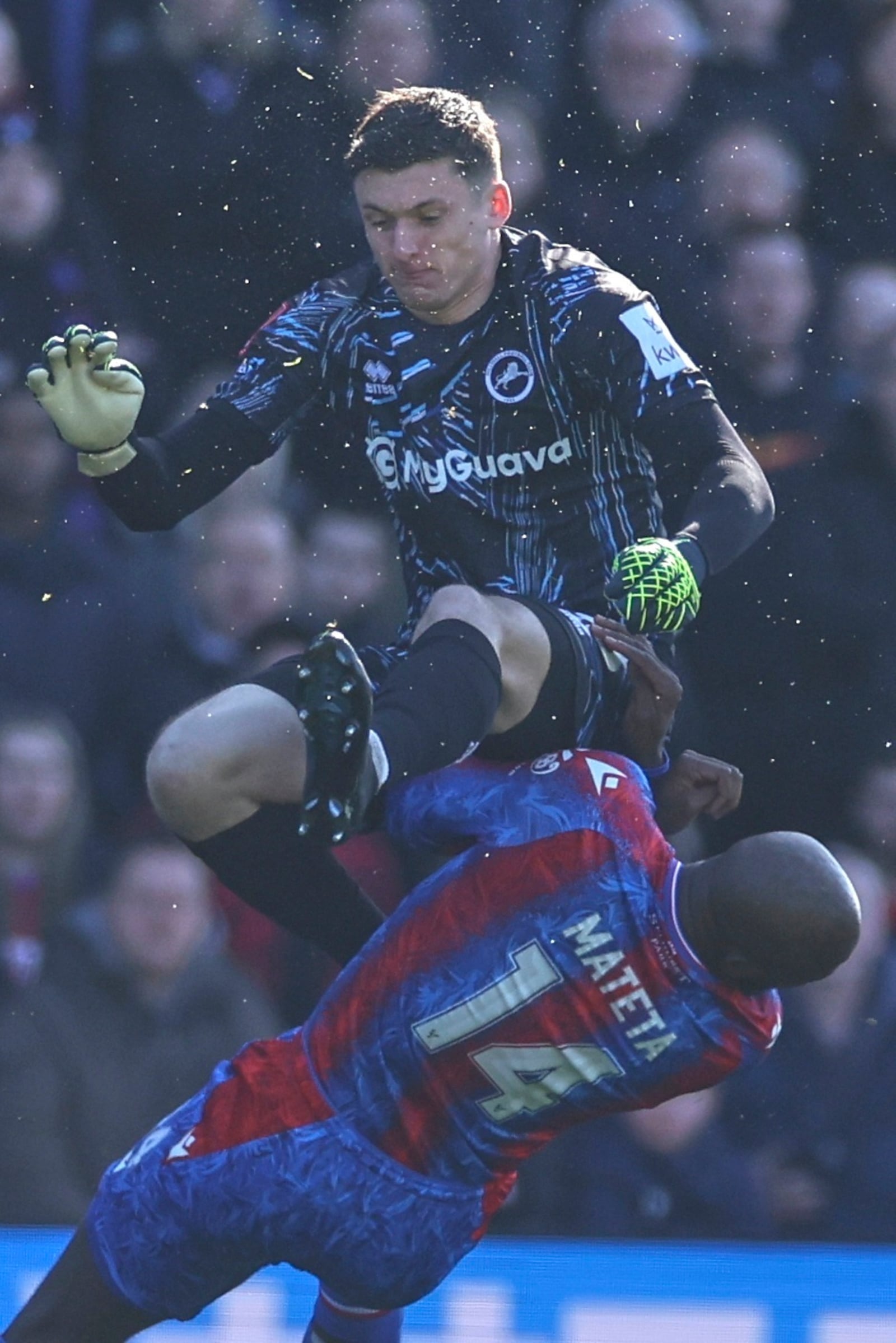 Crystal Palace's Jean-Philippe Mateta is fouled by Millwall goalkeeper Liam Roberts, for which he got a red card, during the English FA Cup soccer match between Crystal Palace and Millwall at Selhurst Park, London, England, Saturday, March 1, 2025. (AP Photo/Ian Walton)