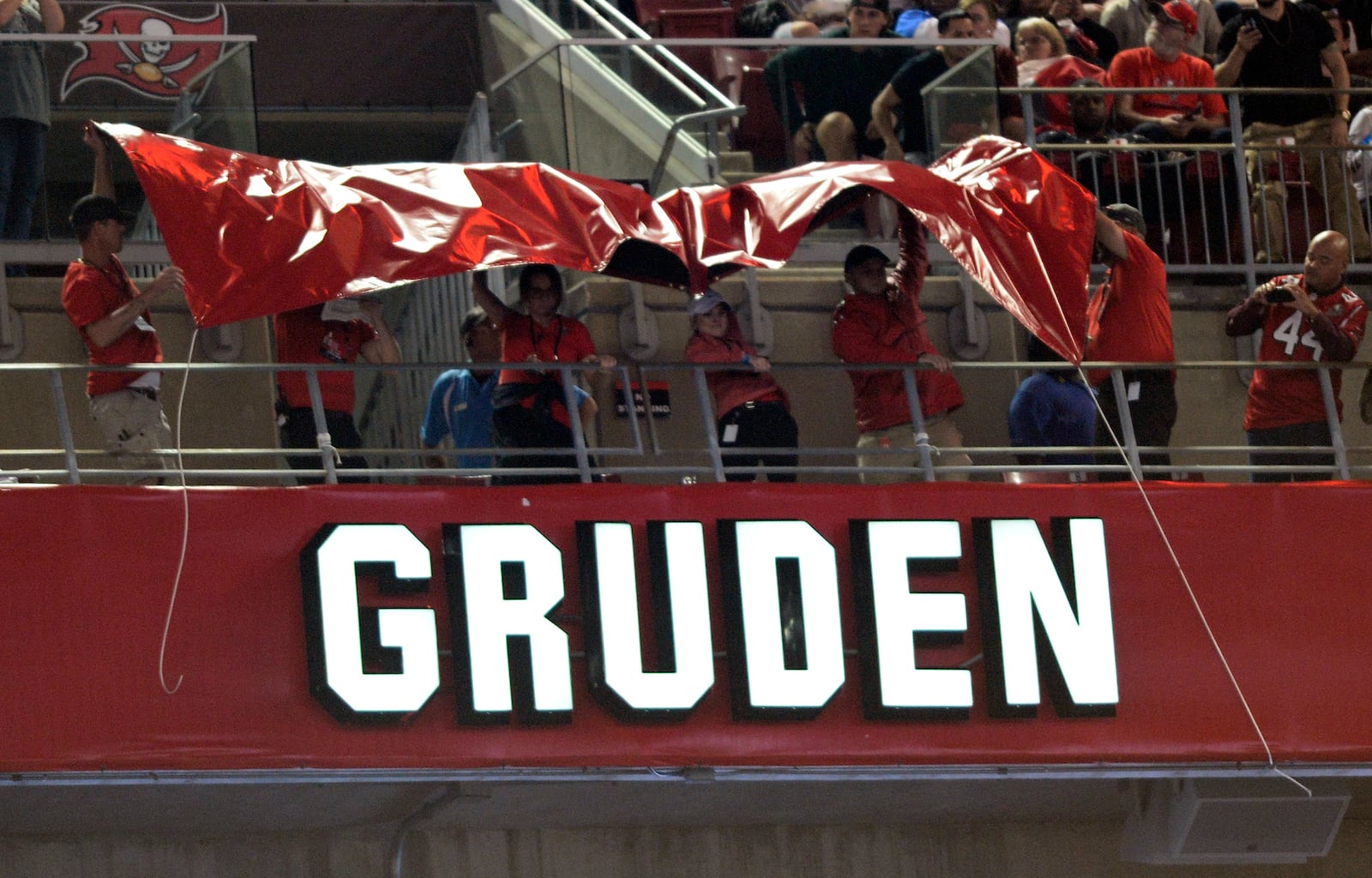 FILE - Former Tampa Bay Buccaneers head coach Jon Gruden's name is uncovered after being inducted into the team's Ring of Honor during the halftime of an NFL football game against the Atlanta Falcons Monday, Dec. 18, 2017, in Tampa, Fla. (AP Photo/Jason Behnken,File)