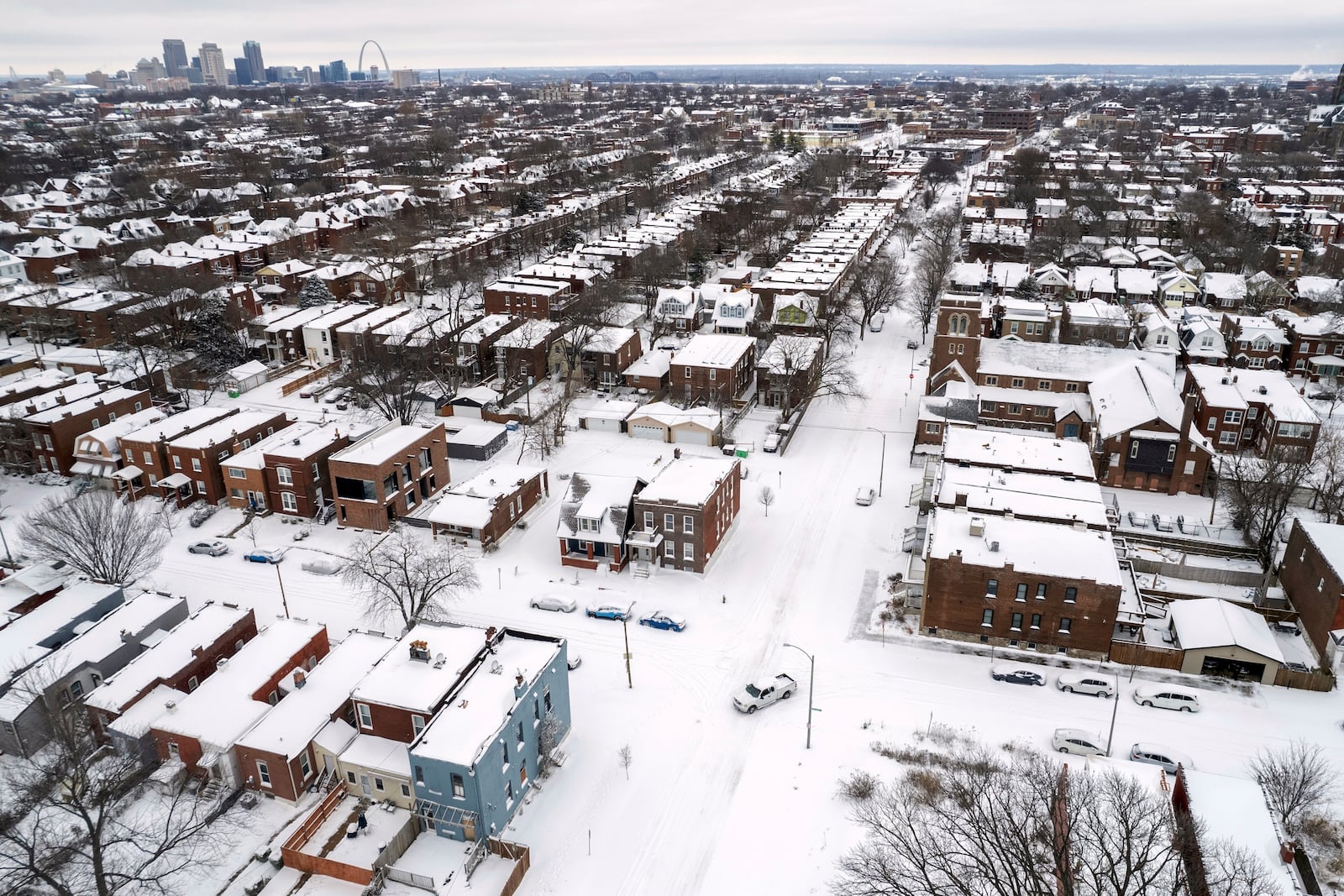 FILE - A pickup truck navigates snow-covered streets following a winter storm, Jan. 6, 2025, in St. Louis. (AP Photo/Jeff Roberson, File)