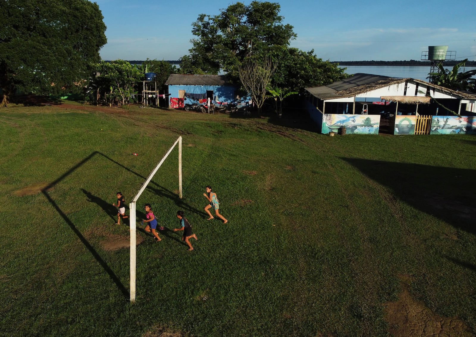 Members of the Mura Indigenous community play in the Moyray village in Autazes, Amazonas state, Brazil, Thursday, Feb. 20, 2025. (AP Photo/Edmar Barros)