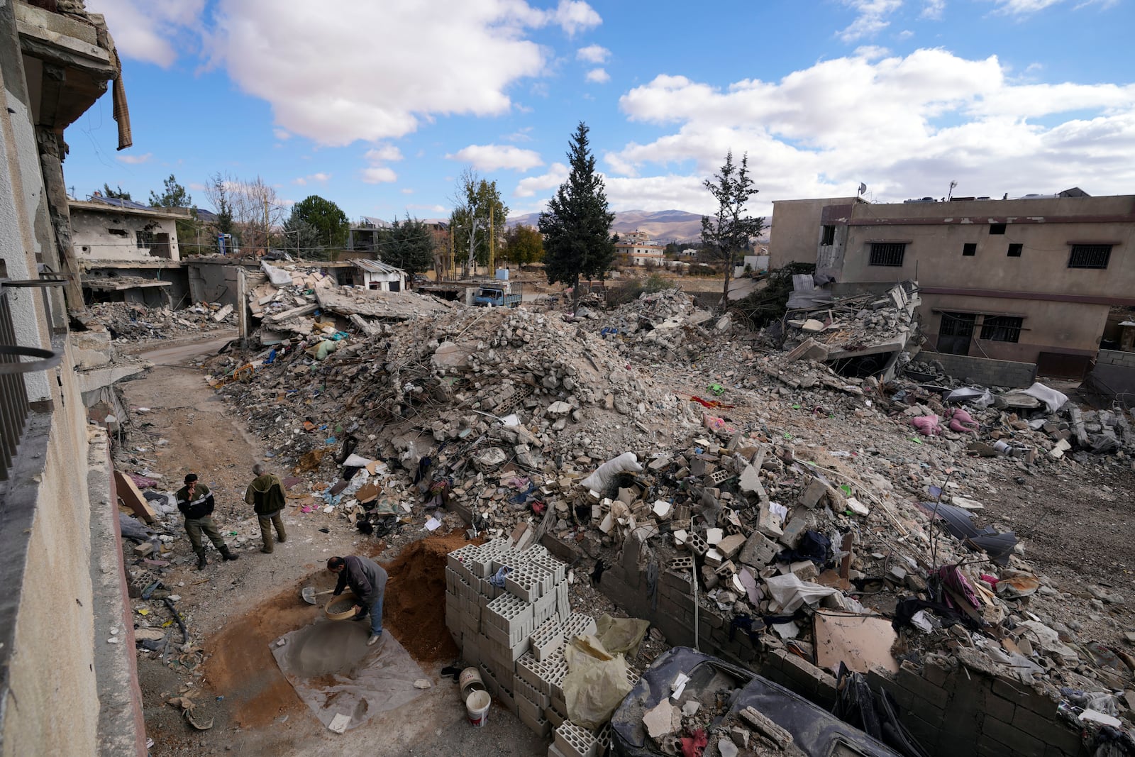 Residents rebuild their houses damaged in Israeli airstrikes, in Baalbek, eastern Lebanon, Thursday, Nov. 28, 2024. (AP Photo/Hassan Ammar)