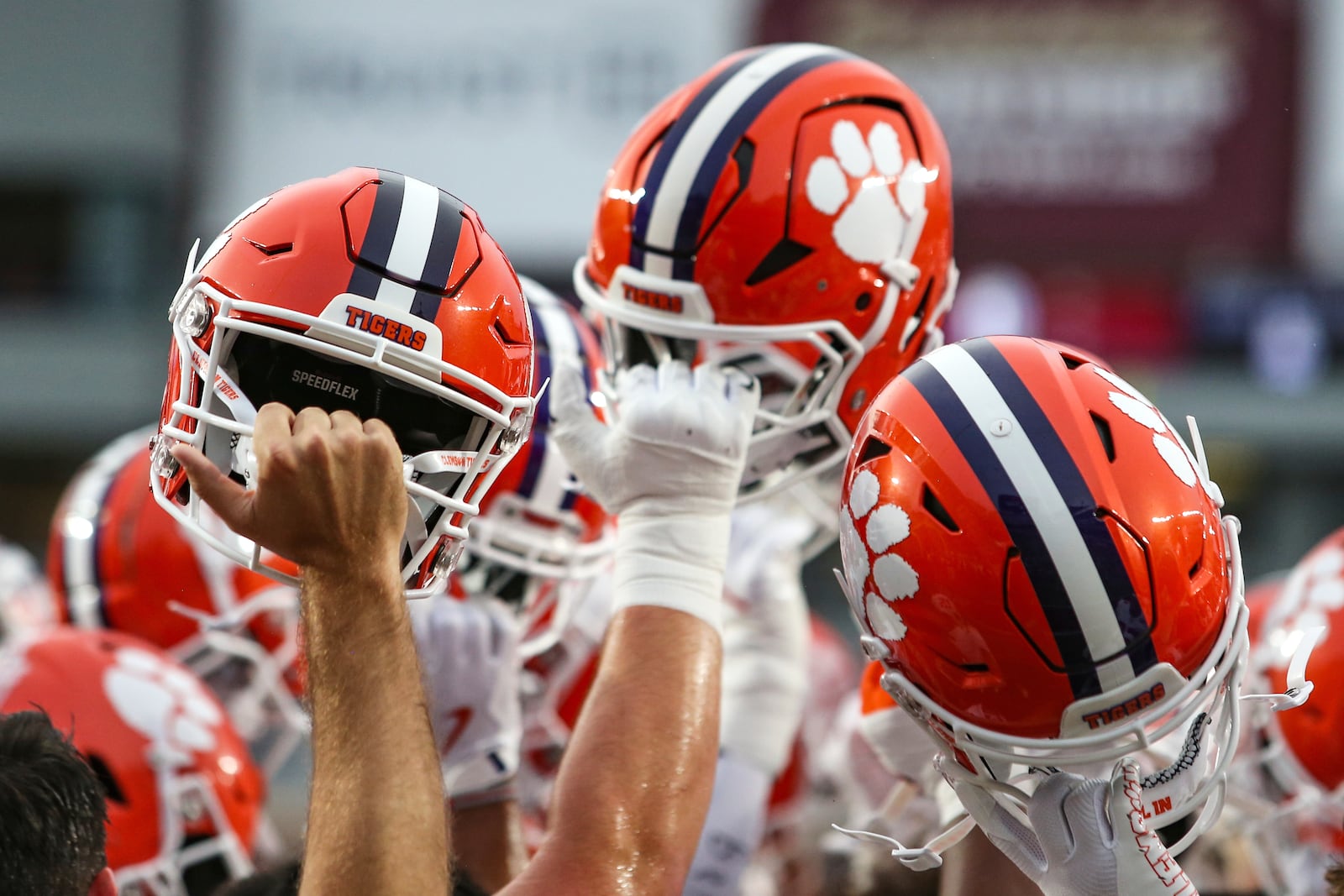 FILE - Clemson players lift their helmet before an NCAA football game against Florida State, Oct. 5, 2024, in Tallahassee, Fla. (AP Photo/Gary McCullough, File)