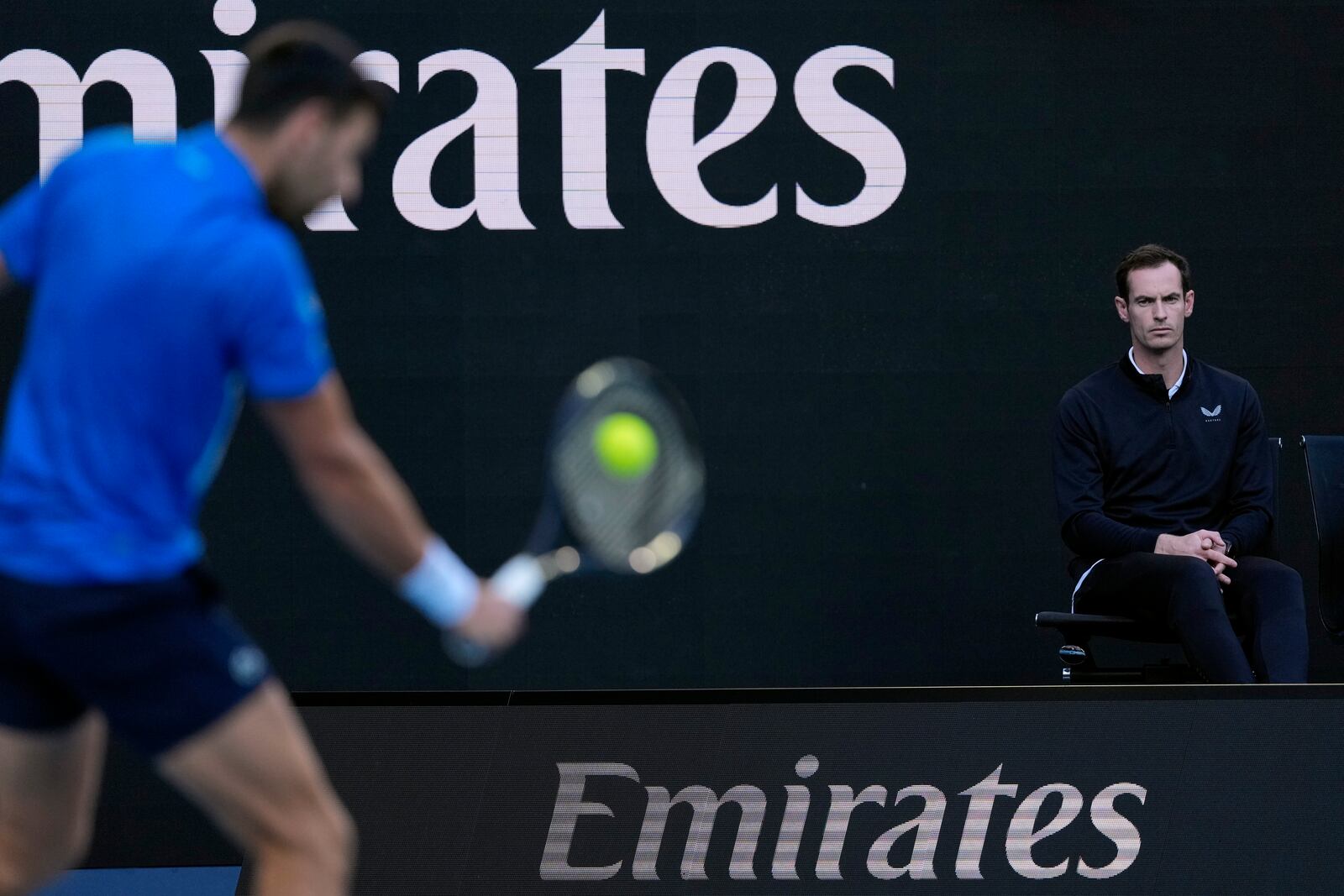 Andy Murray, coach of Novak Djokovic of Serbia watches him during his first round match against Nishesh Basavareddy of the U.S. at the Australian Open tennis championship in Melbourne, Australia, Monday, Jan. 13, 2025. (AP Photo/Asanka Brendon Ratnayake)