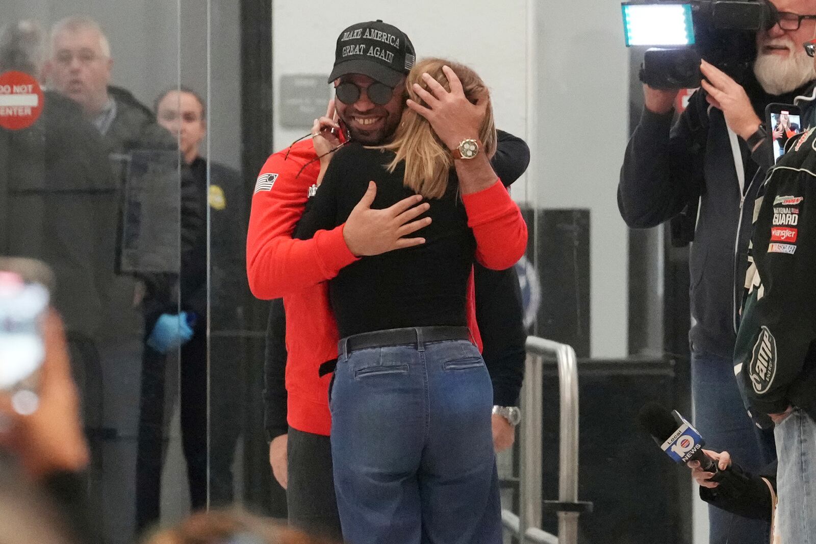 Enrique Tarrio hugs his mother after arriving at Miami International Airport, Wednesday, Jan. 22, 2025, in Miami. Tarrio was pardoned by President Donald Trump after he was convicted of seditious conspiracy for his role in the January 6 attack on the U.S. Capitol. (AP Photo/Marta Lavandier)