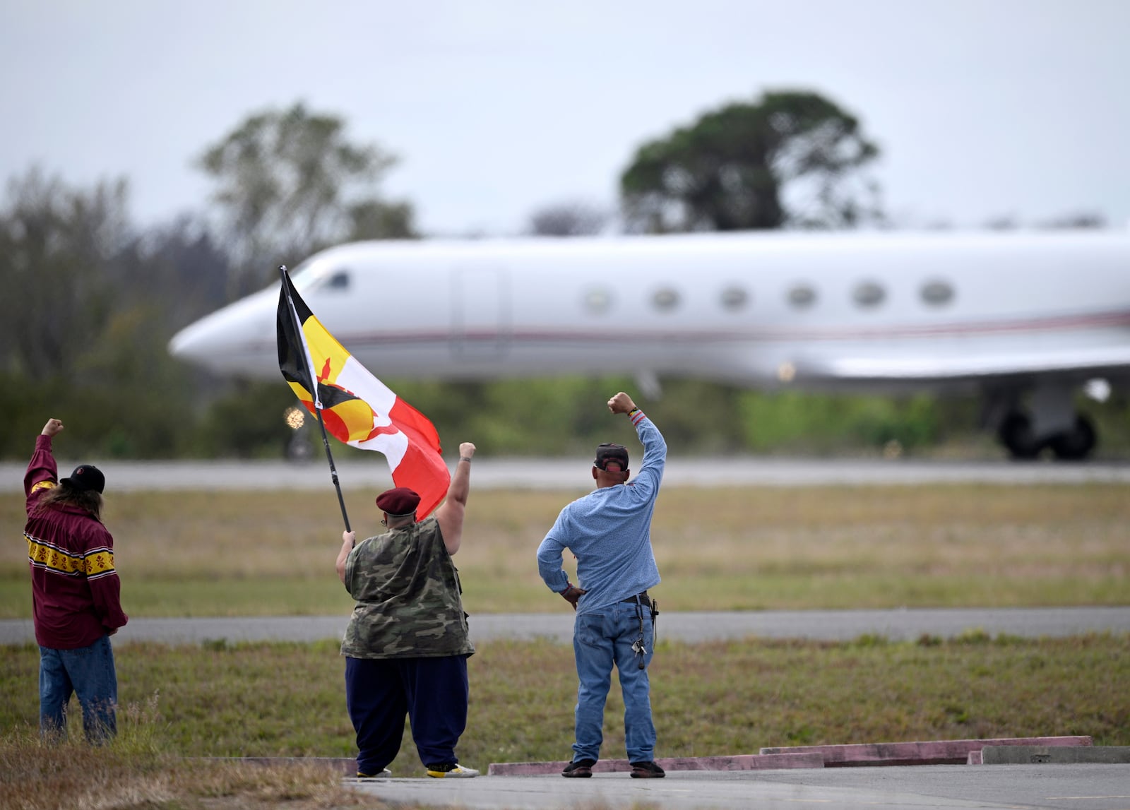 Supporters react as a plane carrying Leonard Peltier takes off from Leesburg International Airport, Tuesday, Feb. 18, 2025, in Leesburg, Fla. (AP Photo/Phelan M. Ebenhack)