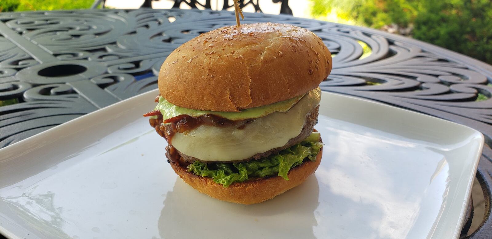 The new Local Burger at The Coach House Tavern & Grille in Hamilton includes an 8-ounce burger patty of meat from Reserve Run Farms in Hanover Twp. and a cracked wheat bun specifically made for the burger by Almond Sisters Bakery in Hamilton. It also features greens and a compote made from tomatoes provides by 80 Acres Farms, which has locations in Hamilton and Cincinnati. ERIC SCHWARTZBERG/STAFF