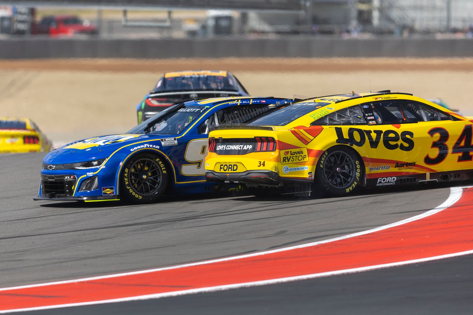 Chase Elliott, front left, and Todd Gilliland (34) connect in Turn 1 during a NASCAR Cup Series auto race at Circuit of the Americas in Austin, Texas, Sunday, March 2, 2025. (AP Photo/Stephen Spillman)