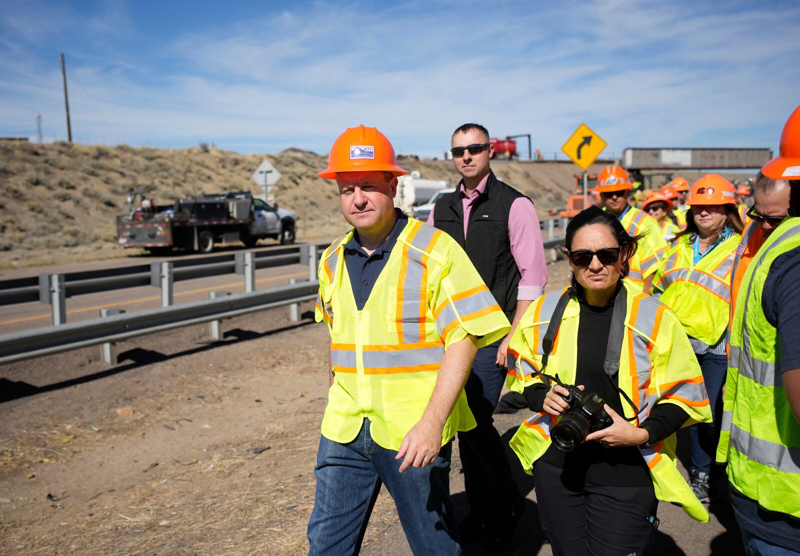 FILE - Colorado Gov. Jared Polis tours as workers toil to resurface Interstate 25 northbound Oct. 18, 2023, north of Pueblo, Colo. (AP Photo/David Zalubowski, File)