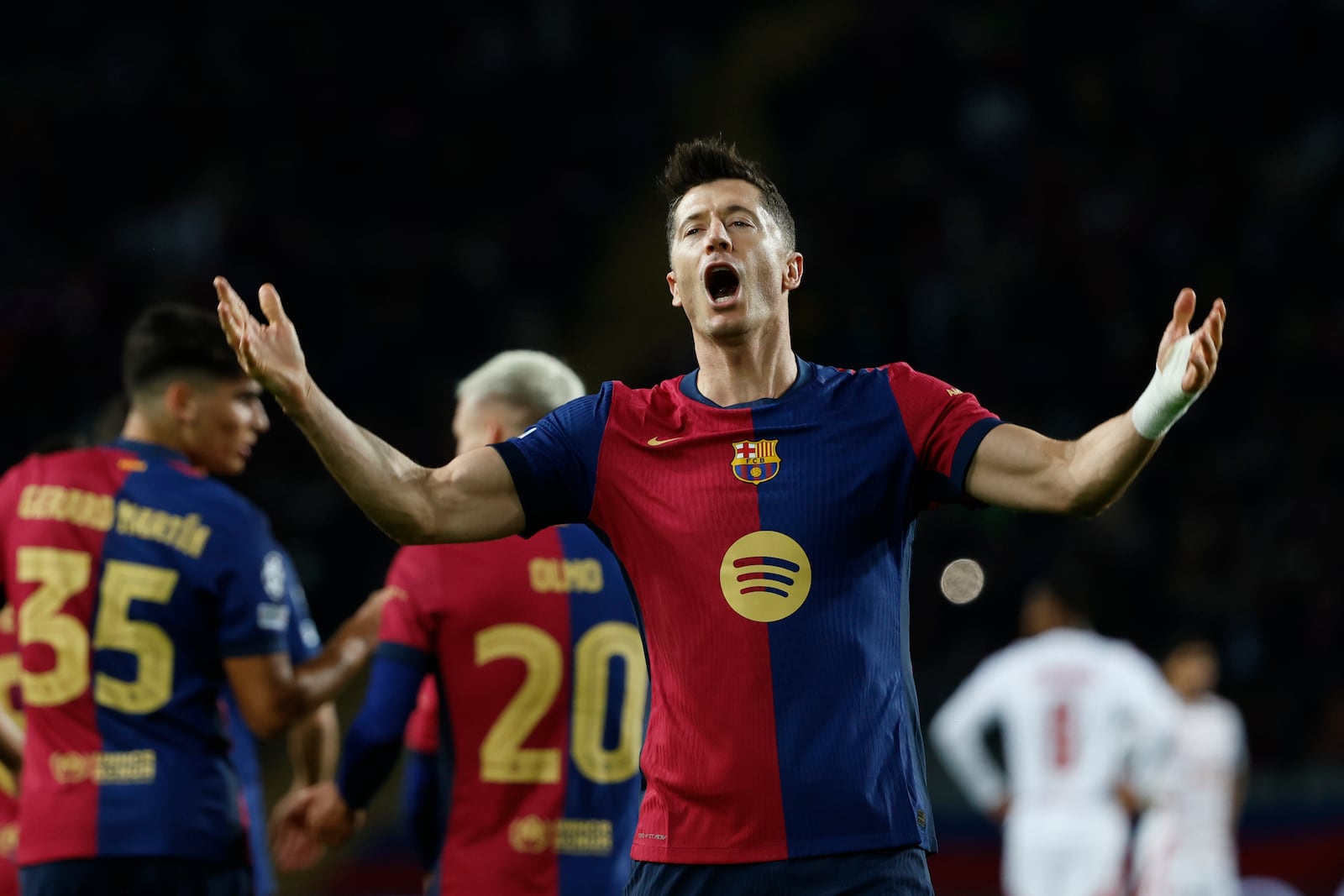 Barcelona's Robert Lewandowski celebrates after scoring his team's first goal during a Champions League phase soccer Matchday 5 between Barcelona and Brest at the Lluis Companys Olympic Stadium in Barcelona, Spain, Tuesday, Nov. 26, 2024. (AP Photo/Joan Monfort)