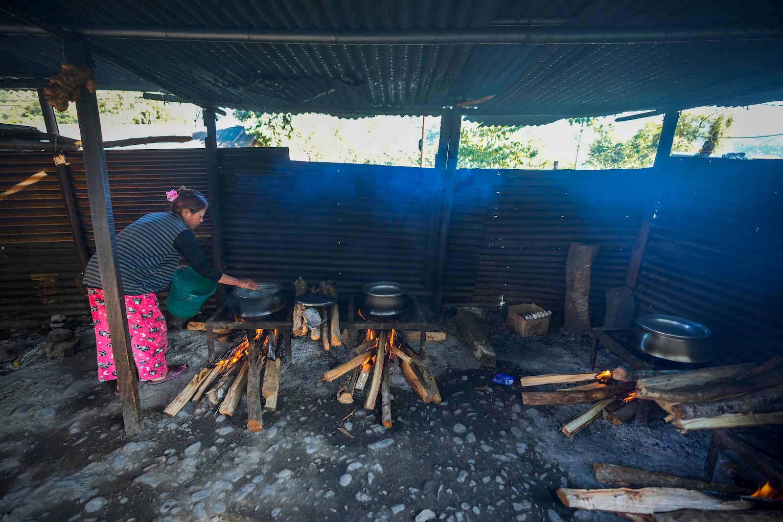 A Kuki tribal cooks food in a relief camp in Kangpokpi, Manipur, Sunday, Dec. 15, 2024. (AP Photo/Anupam Nath)